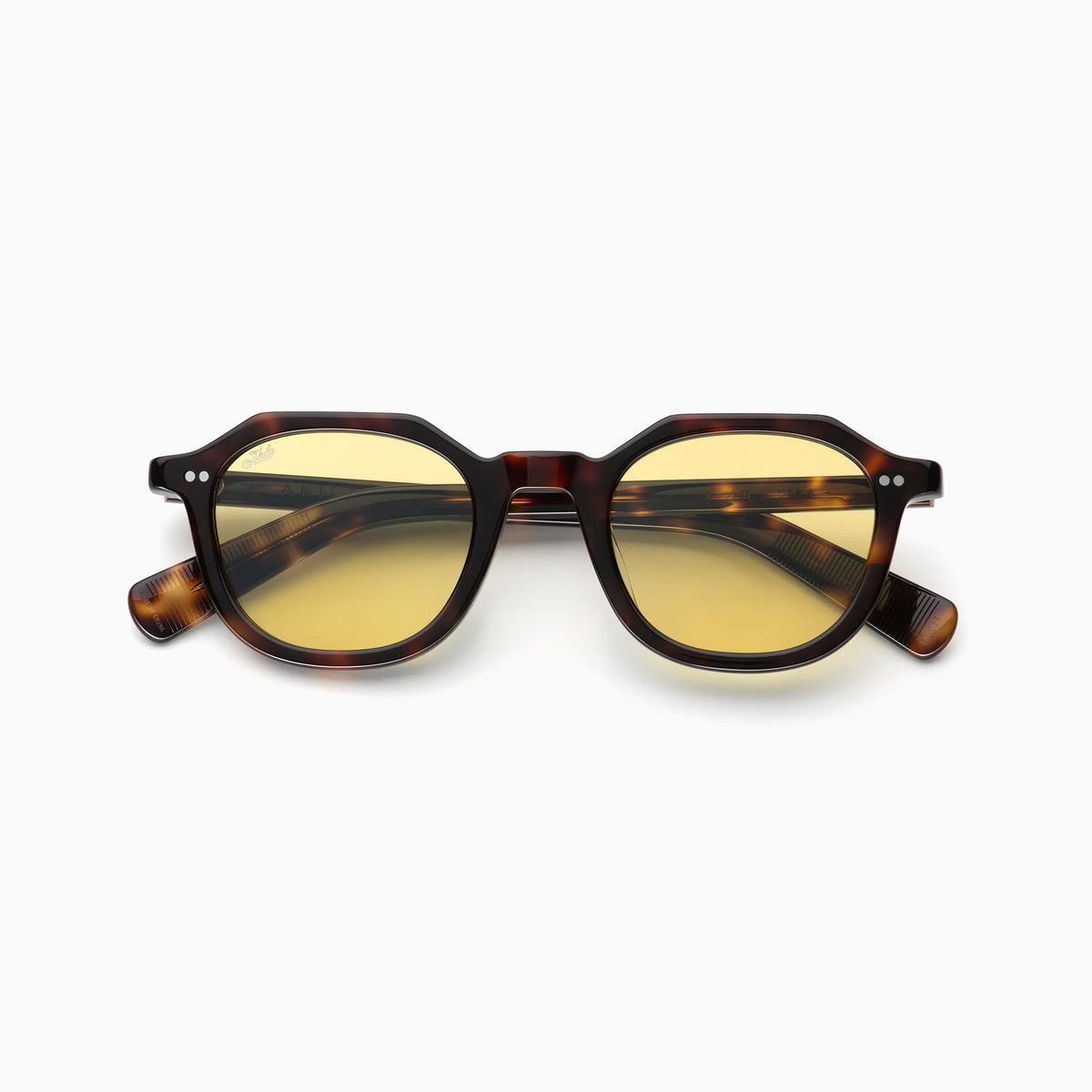 Akila Eira round tortoiseshell glasses with yellow-tinted lenses, inspired by mid-century French crown panto design, from Akila, placed on a white background and facing forward.