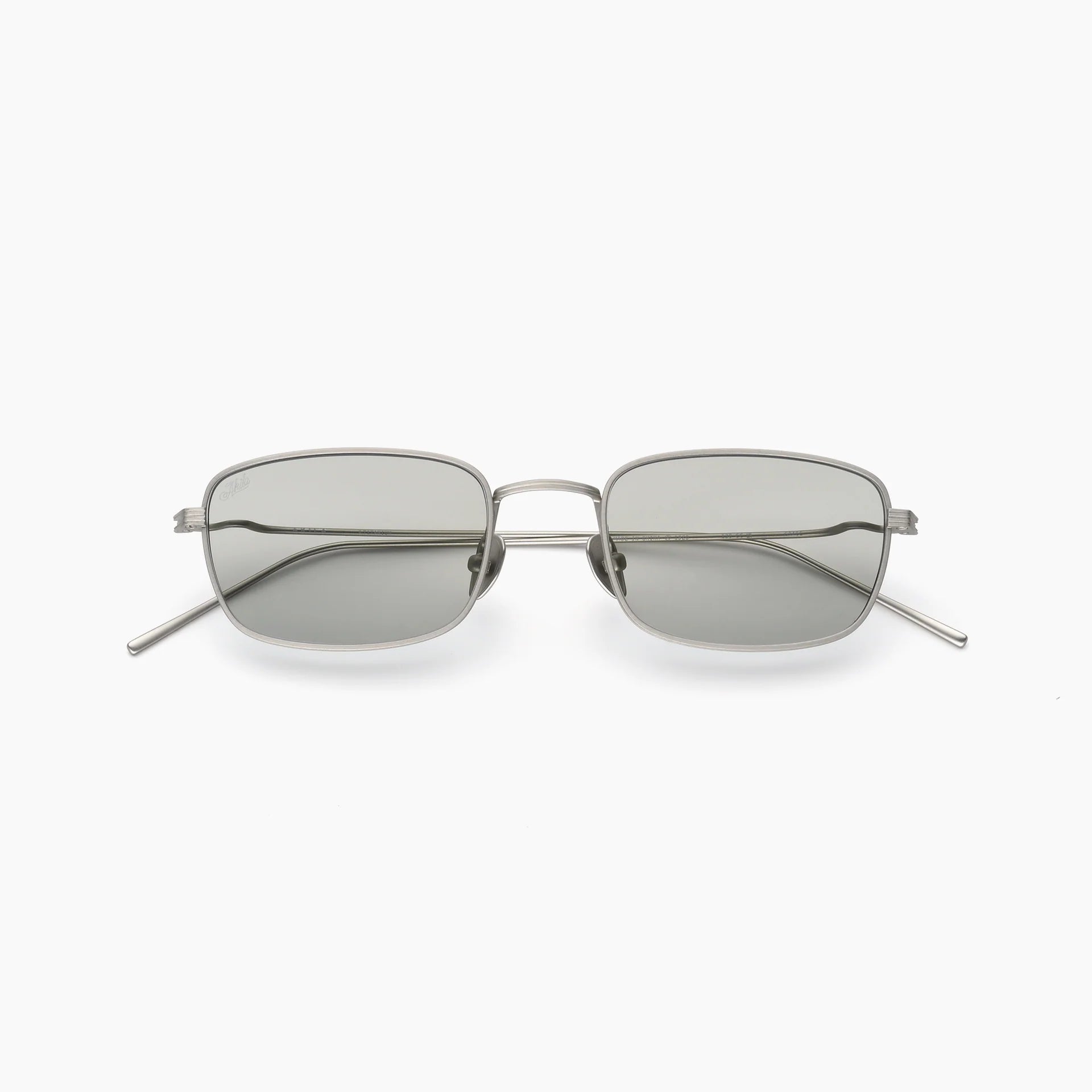 Silver rectangular wire-frame sunglasses with light grey tinted lenses, adjustable nose pads, and slim metal temples shown front-facing on a white background.