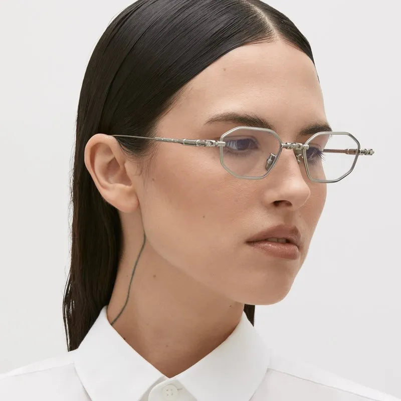 Person wearing glasses with a plain background