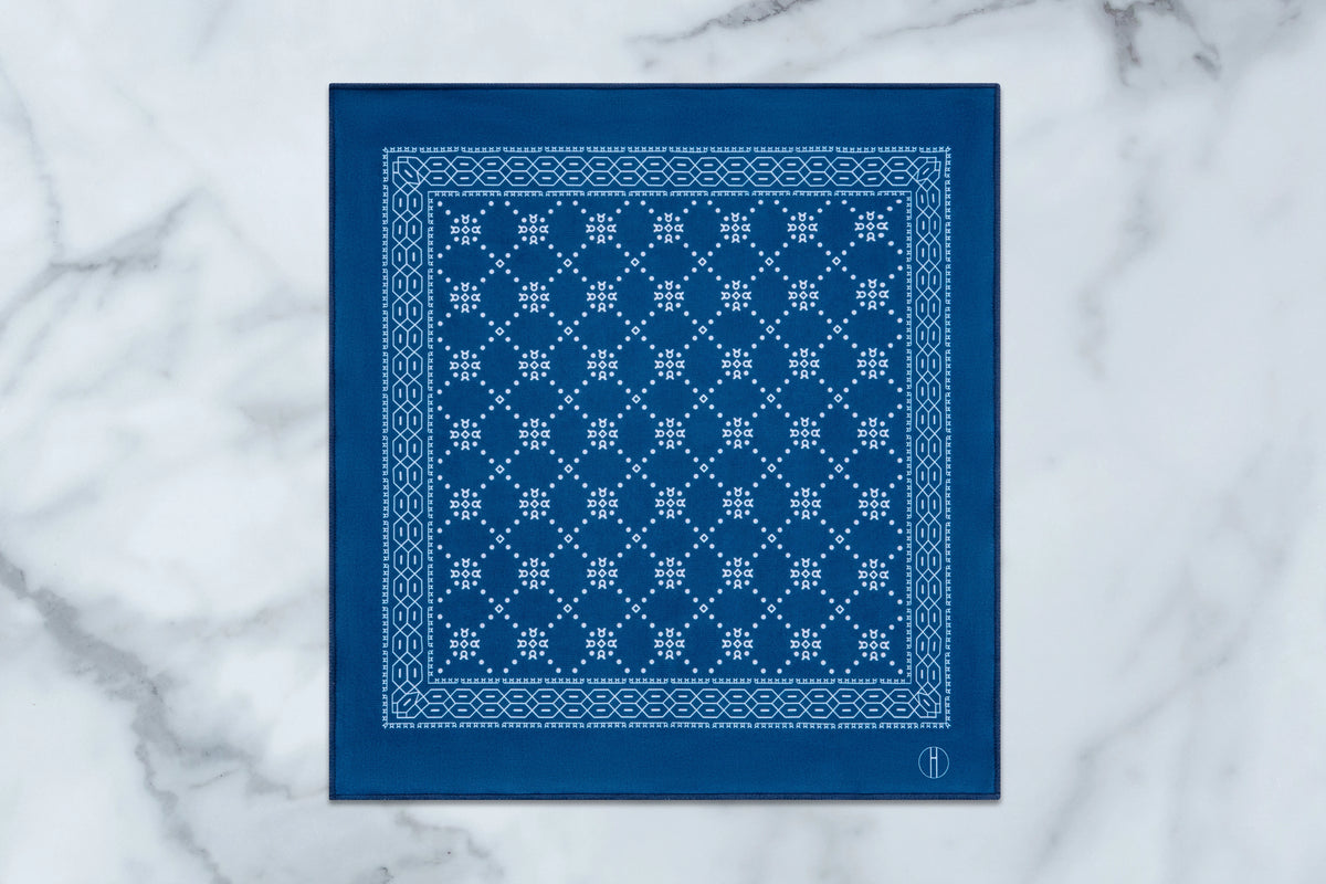Jacques Marie Mage A Decade of Hopper: Pepper square dark blue bandana, featuring a white geometric pattern of small dots and cross-like motifs, a patterned border, and a small H logo in the bottom right corner.