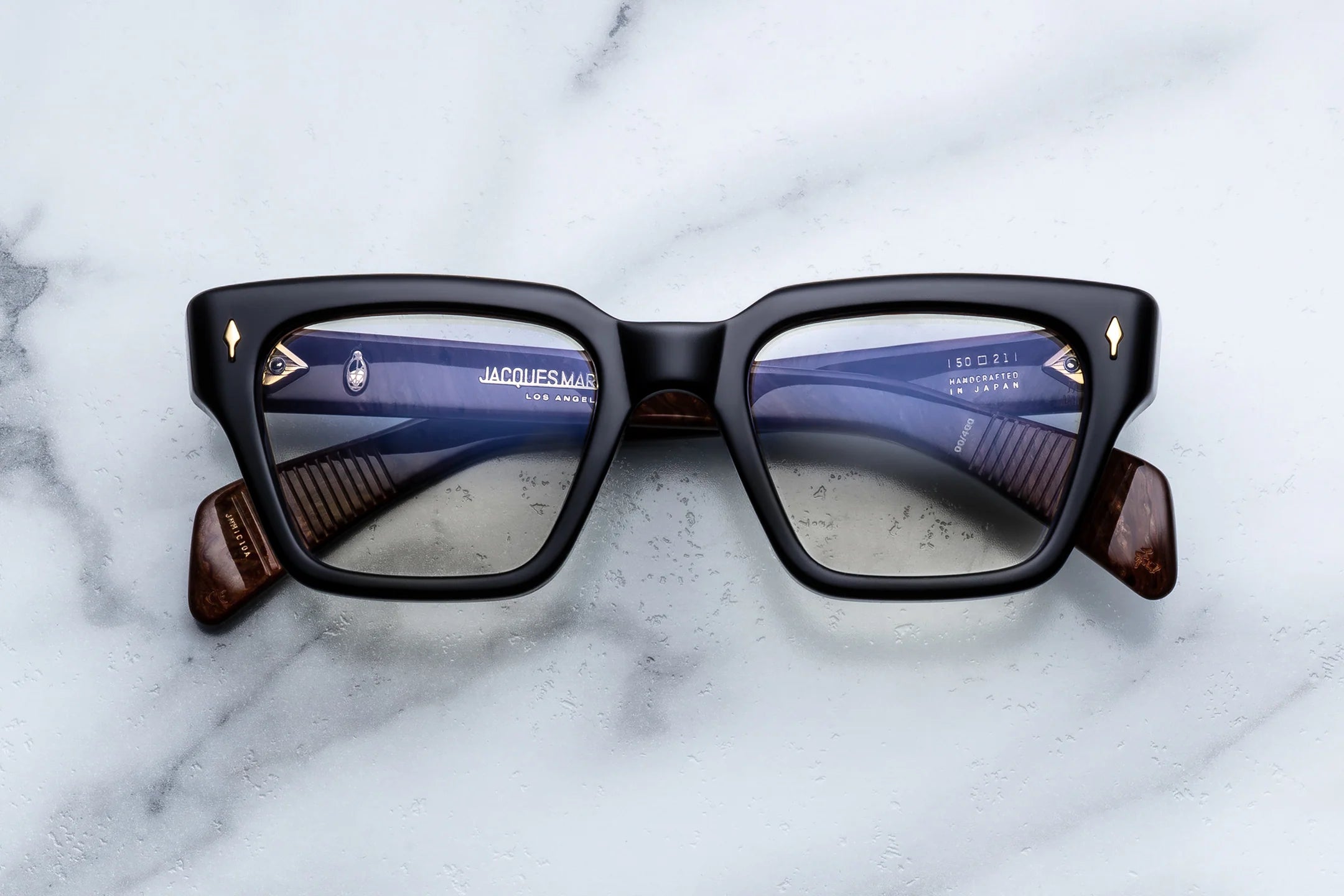 Sunglasses with a reflective surface on a marble background