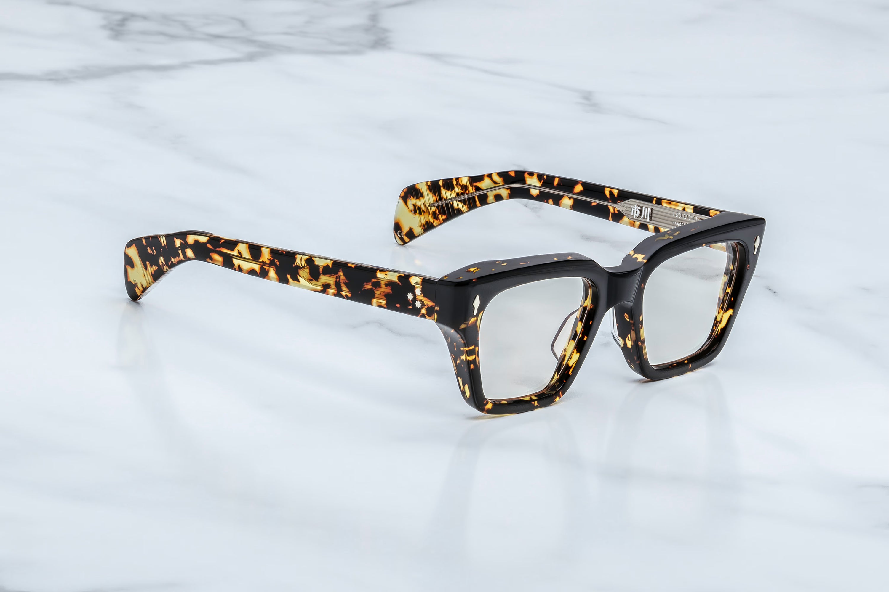 Eyeglasses with tortoiseshell frame on a marble surface