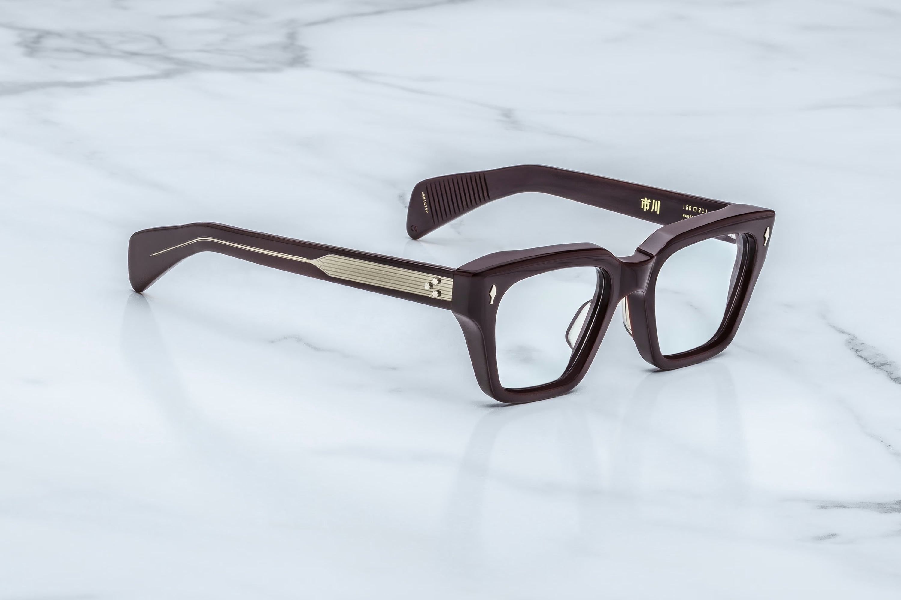 Brown eyeglasses on a white marble surface