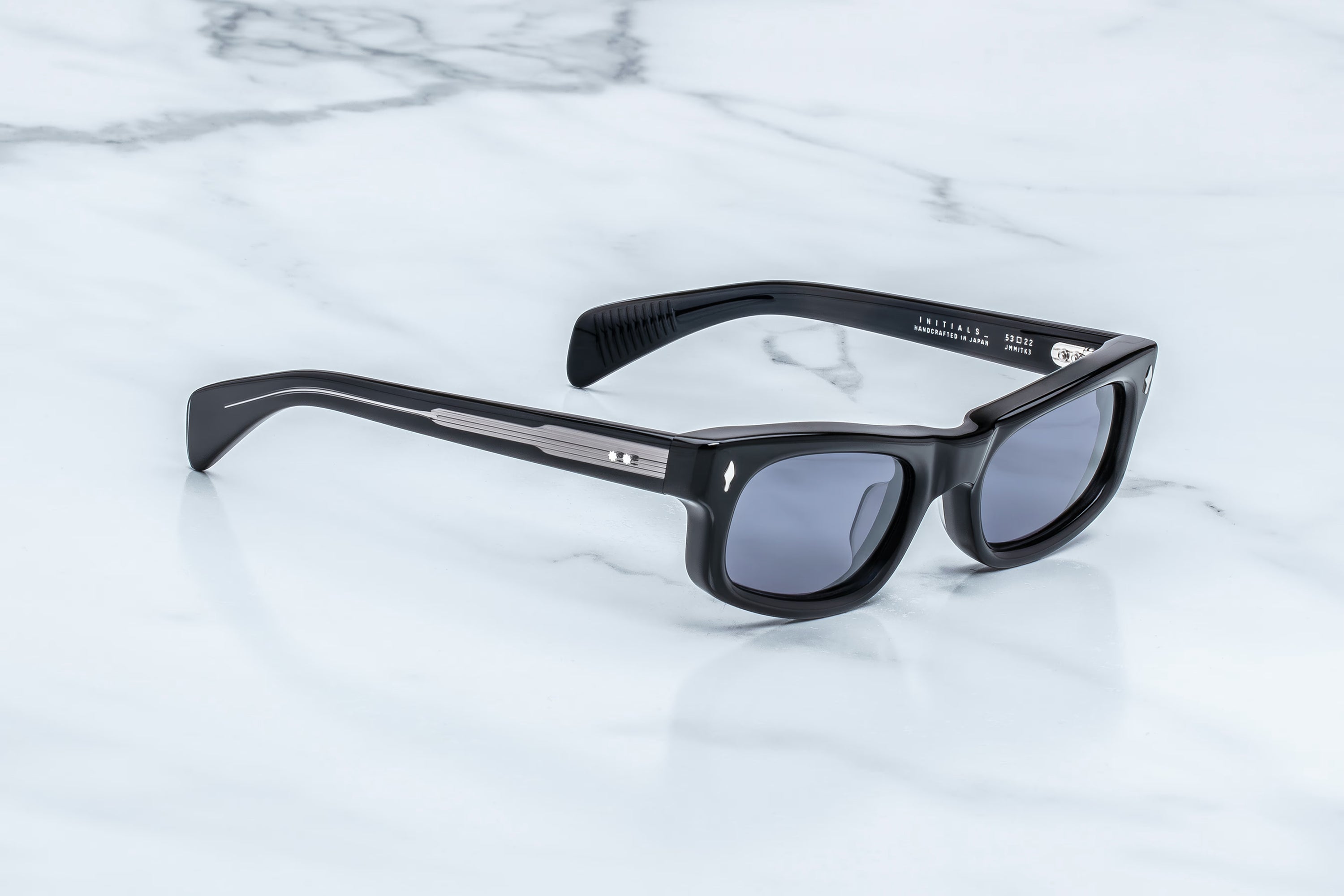 Black sunglasses on a marble surface