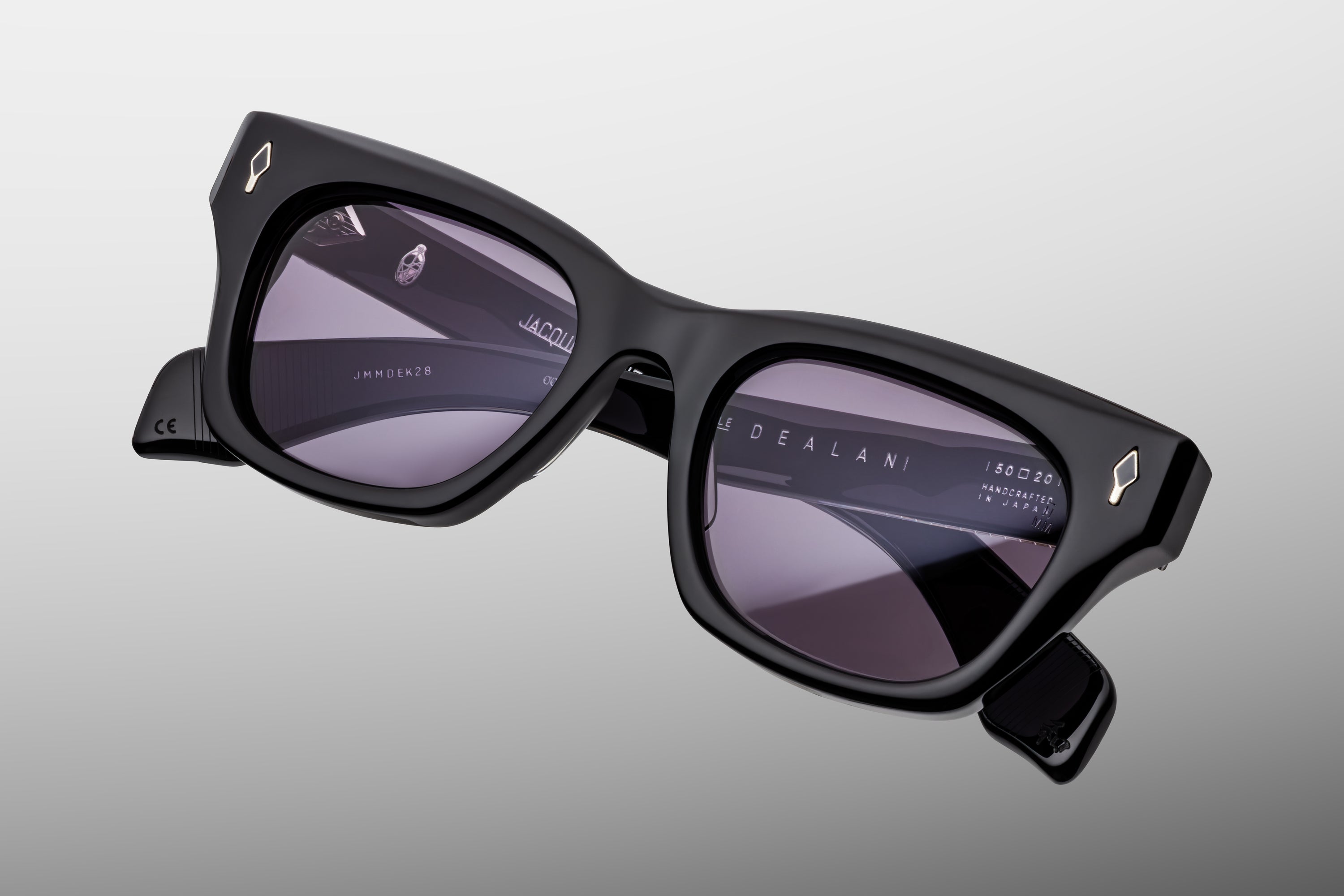 CLassic Black sunglasses with purple lenses on a gray background