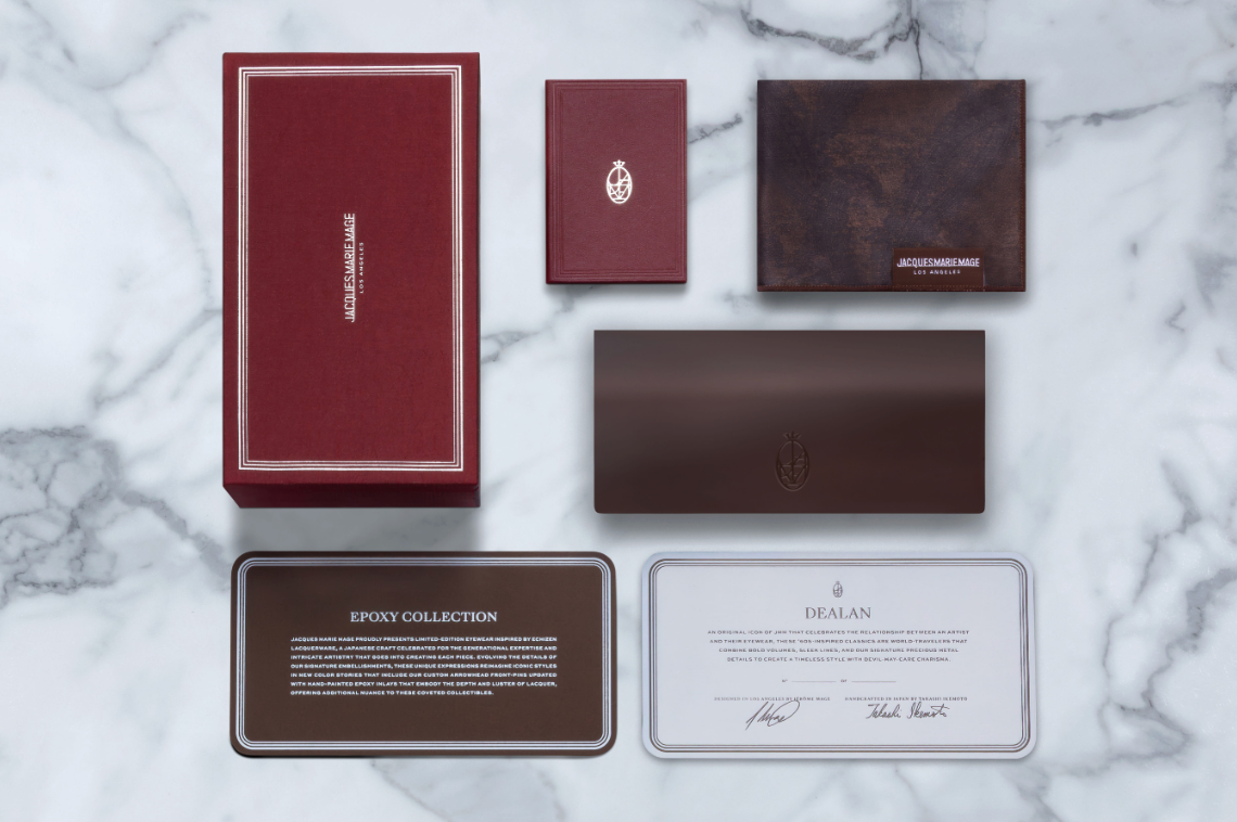 Collection of branded JMM packaging on a marble surface