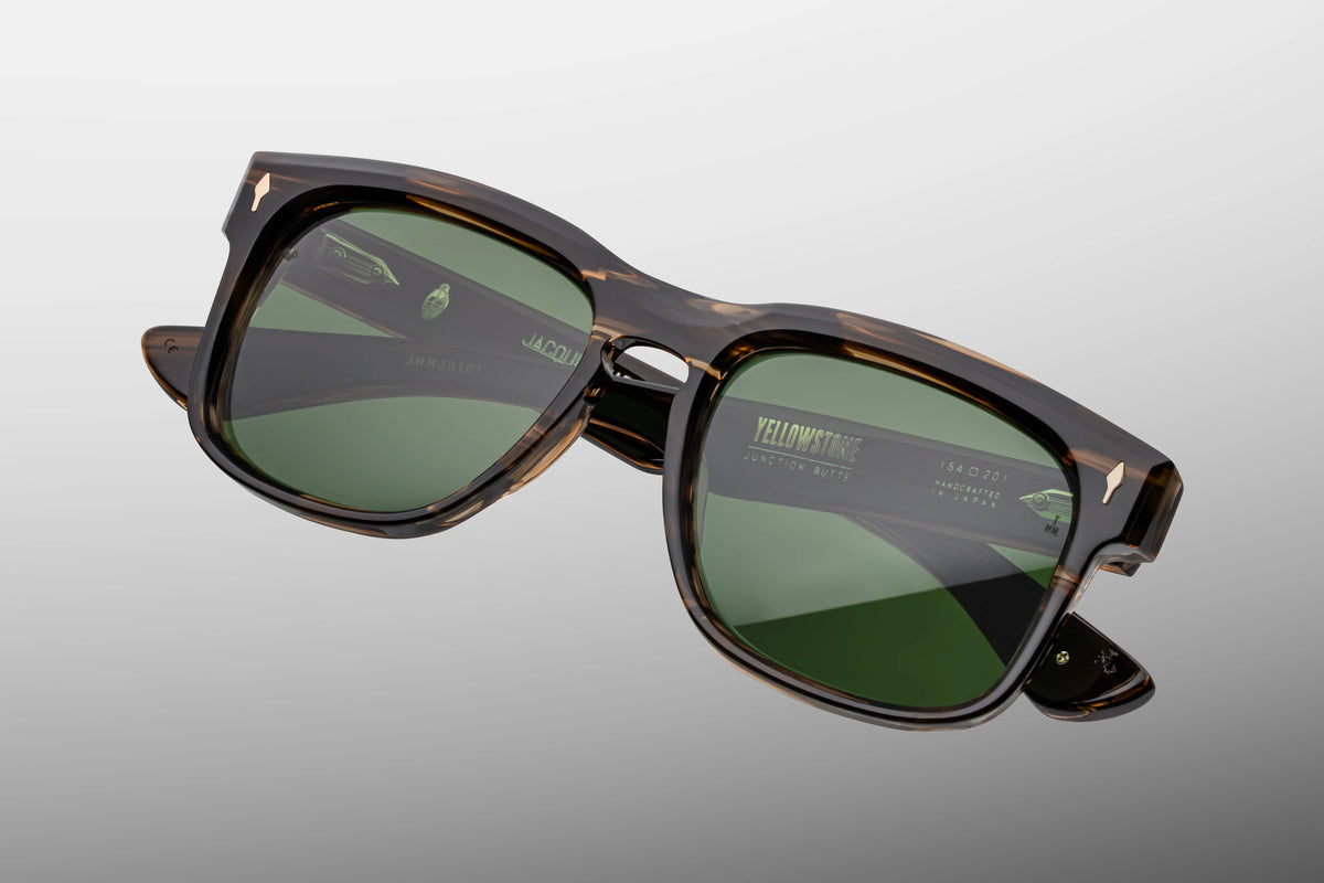 Jacques Marie Mage Yellowstone VII: Junction Butte In Lodgepole handcrafted acetate spectacles with tortoise-patterned rectangular frames, green polarized glass lenses, and YELLOWSTONE JUNCTION BUTTE printed on the right lens.