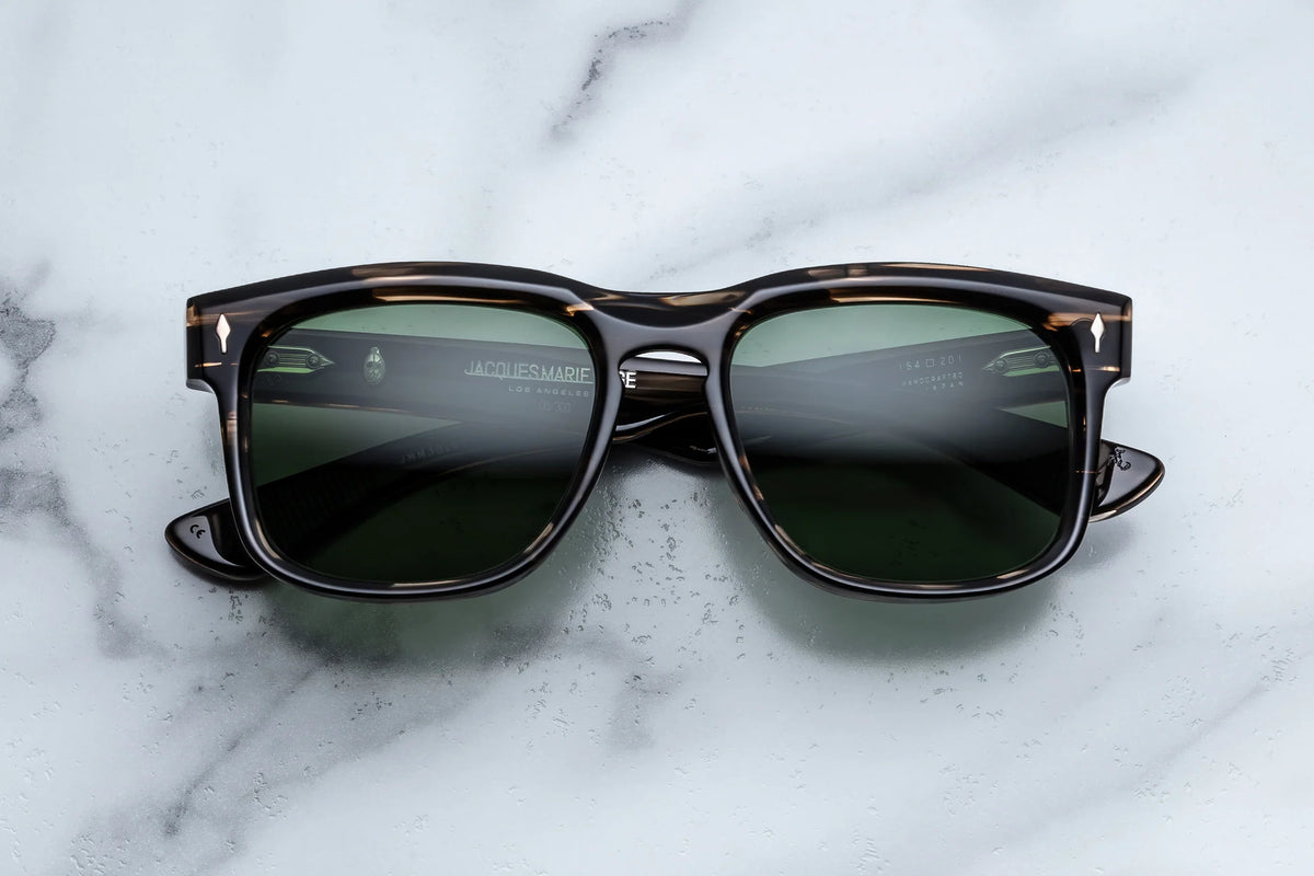 Jacques Marie Mage Yellowstone VII: Junction Butte In Lodgepole handcrafted acetate sunglasses in dark brown tortoiseshell with rectangular frames and dark green polarized glass lenses.