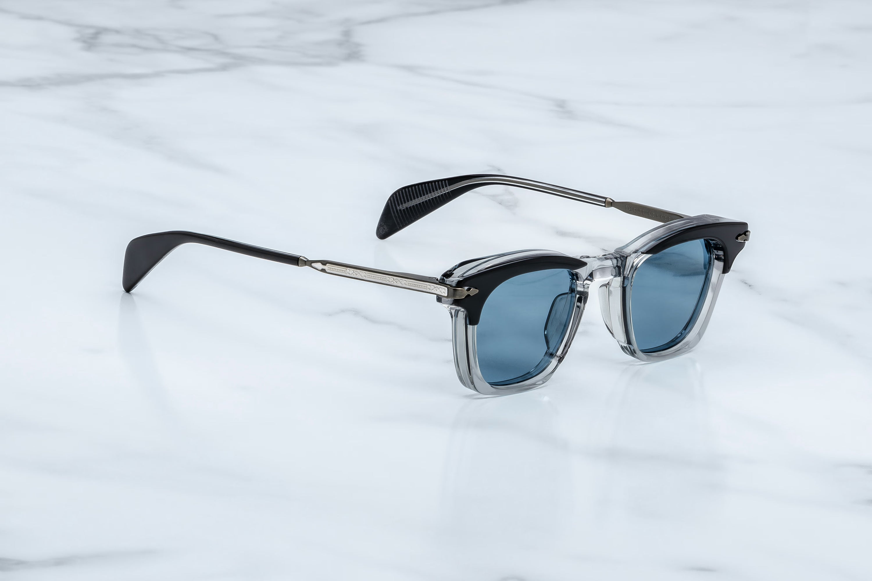 Sunglasses with blue lenses on a marble surface