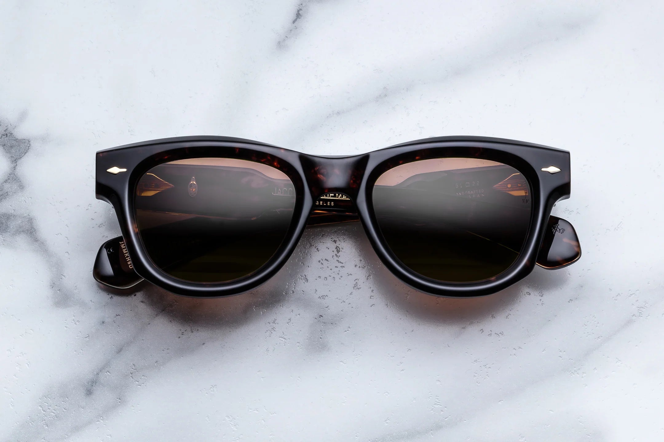 Sunglasses with a tortoiseshell frame on a marble surface