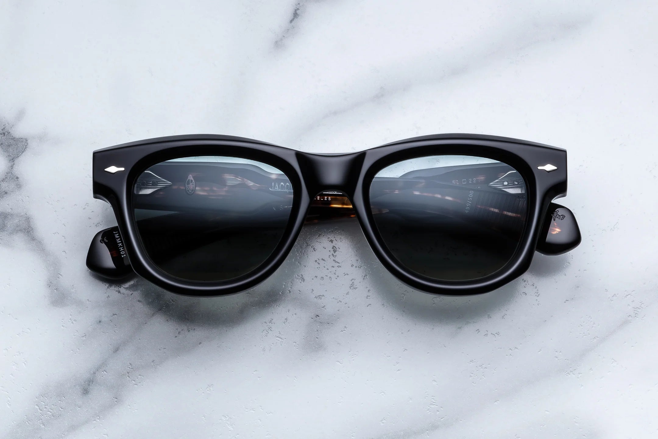 Black sunglasses on a marble surface