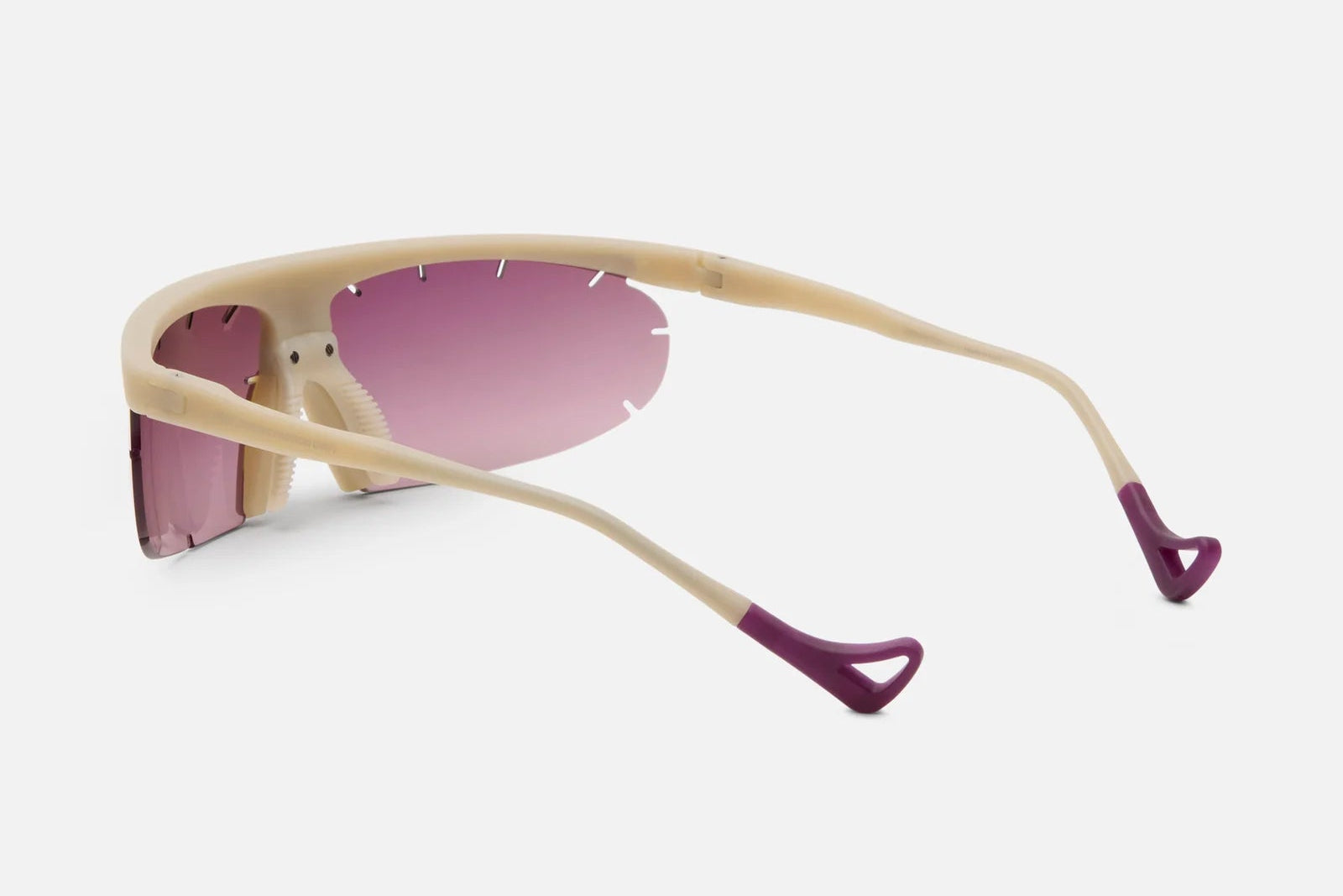 Sunglasses with beige frame and pink lenses on a white background