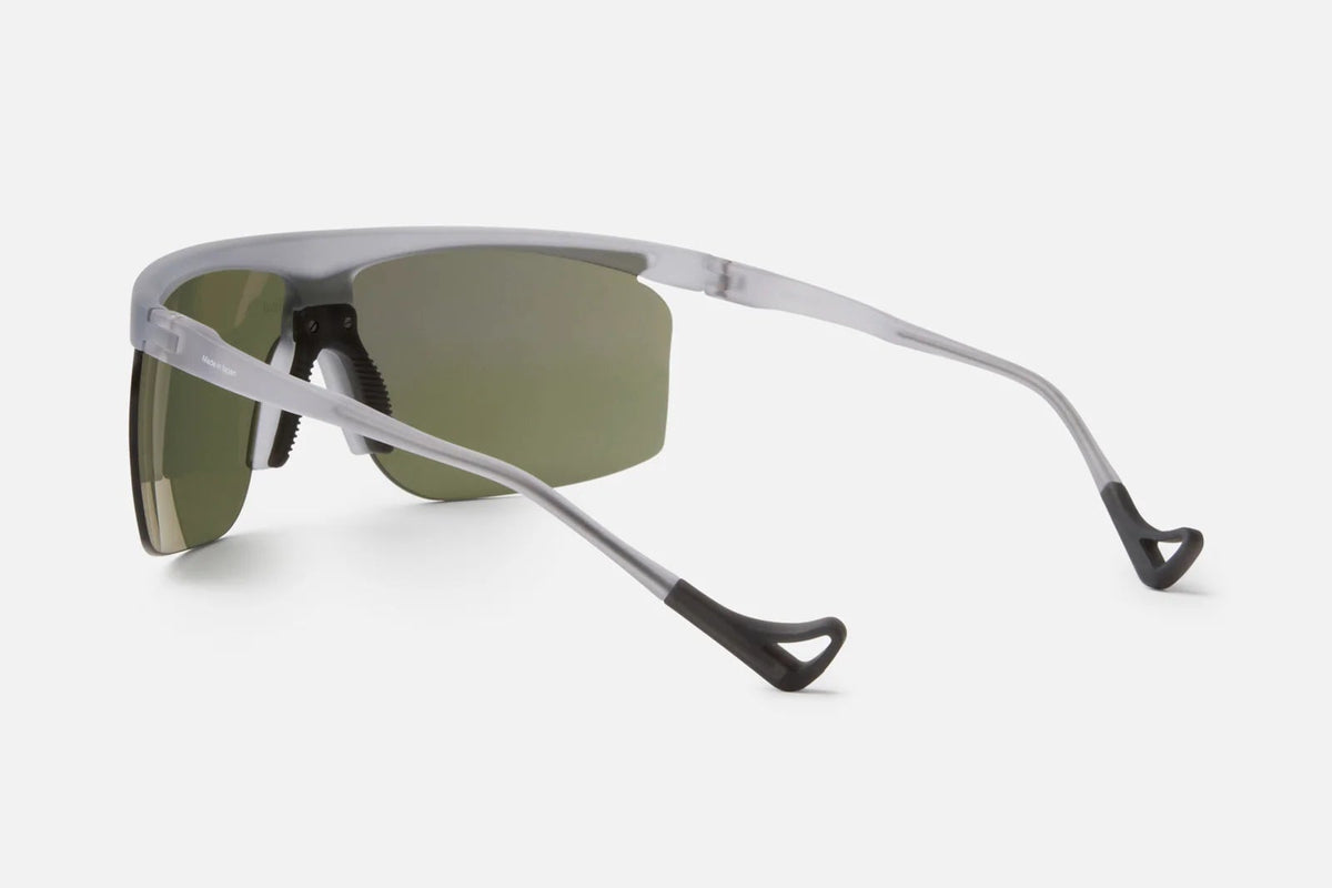 A pair of District Vision Konoha Sun Sprinter sunglasses, featuring slim silver frames, black nose pads, and rectangular blade lenses equipped with advanced D+ lens technology, displayed from the back at an angle against a plain white background—ideal for anyone desiring the innovative style of District Vision.