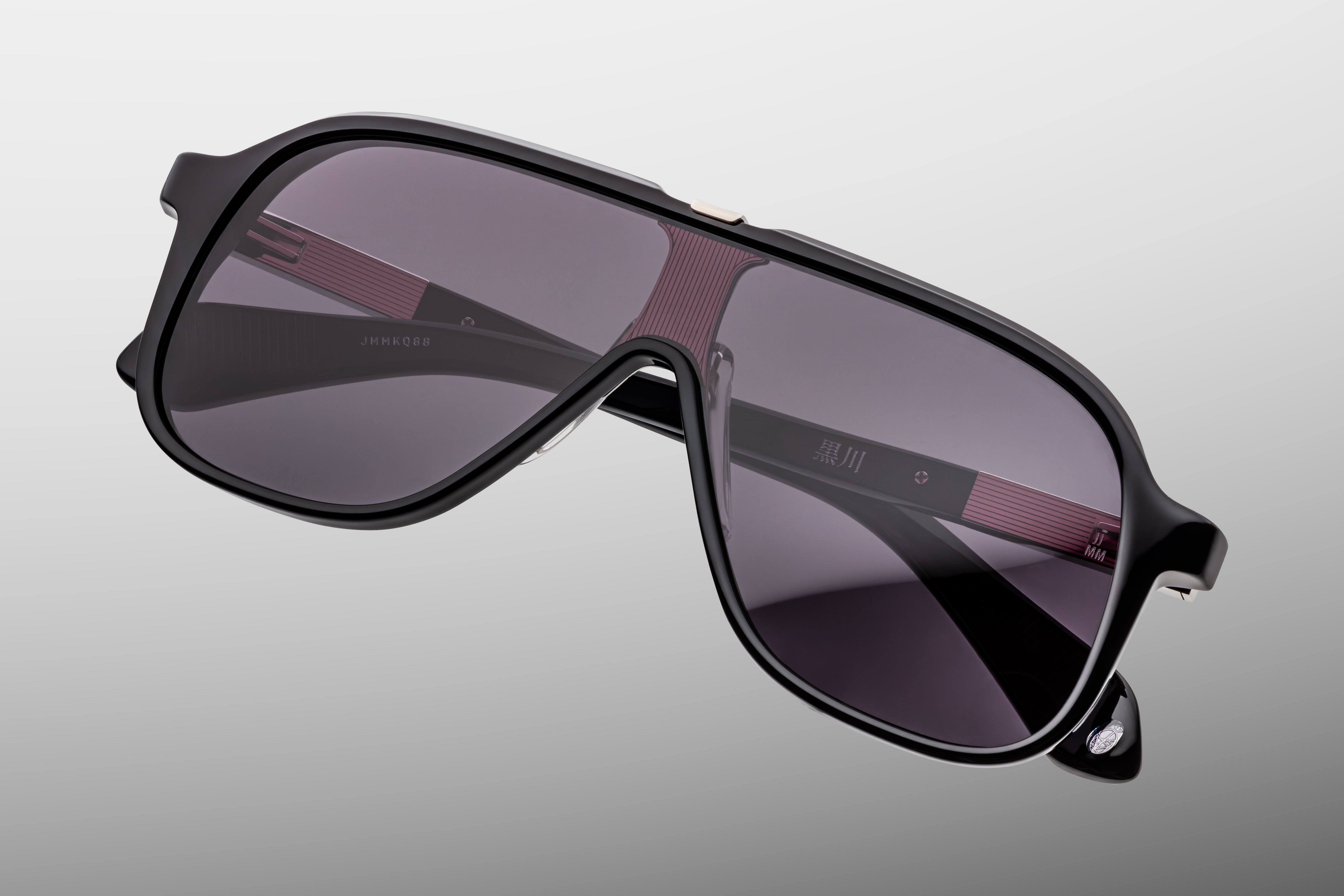 jacques marie mage kurokawa Sunglasses with a black frame and dark lenses on a gray background