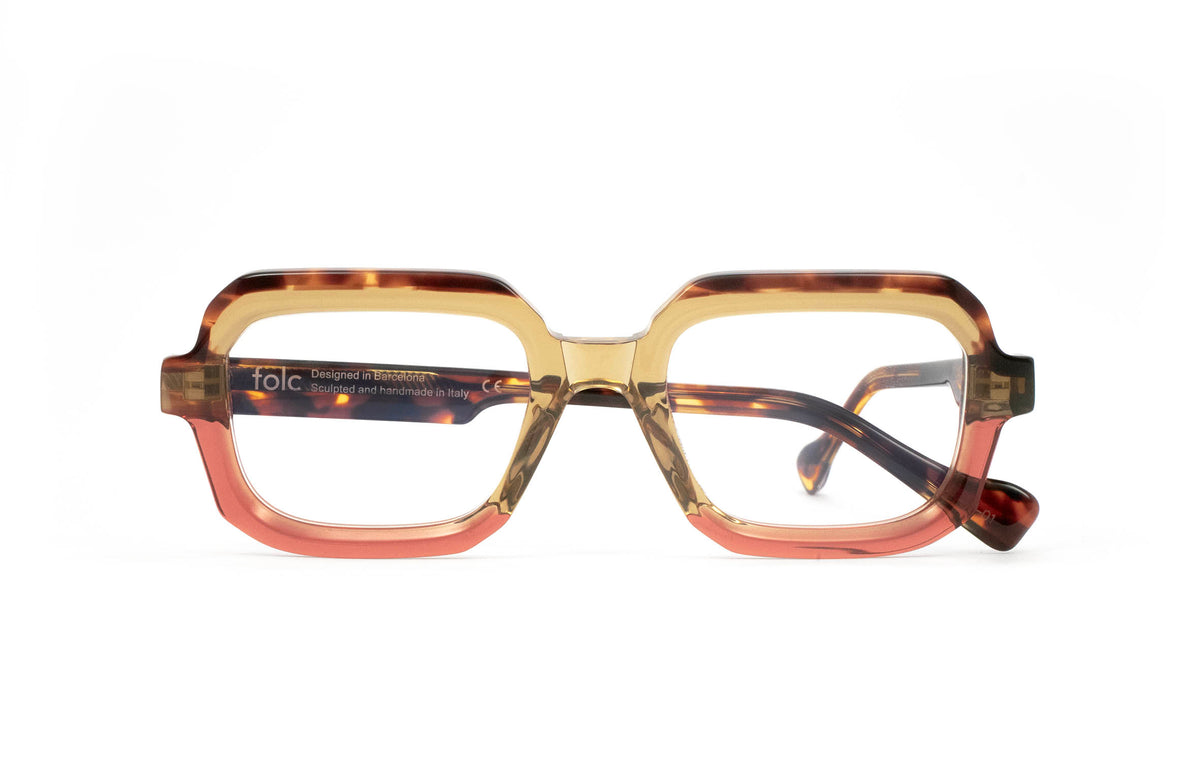 Folc Lapso geometric, contemporary eyewear featuring a translucent tan top frame, a coral pink bottom rim, and tortoise-patterned temples.