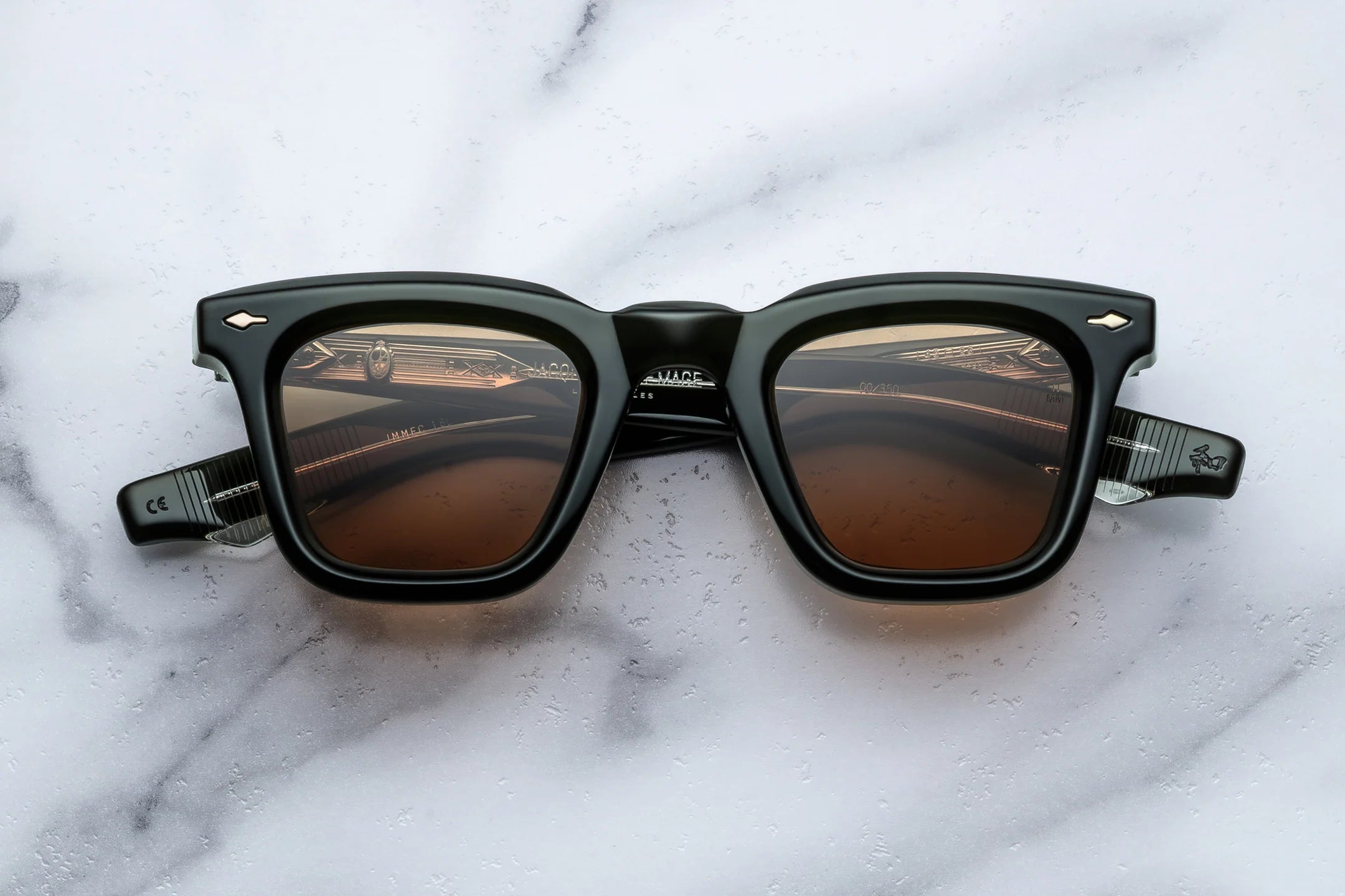 Sunglasses with brown lenses on a marble surface