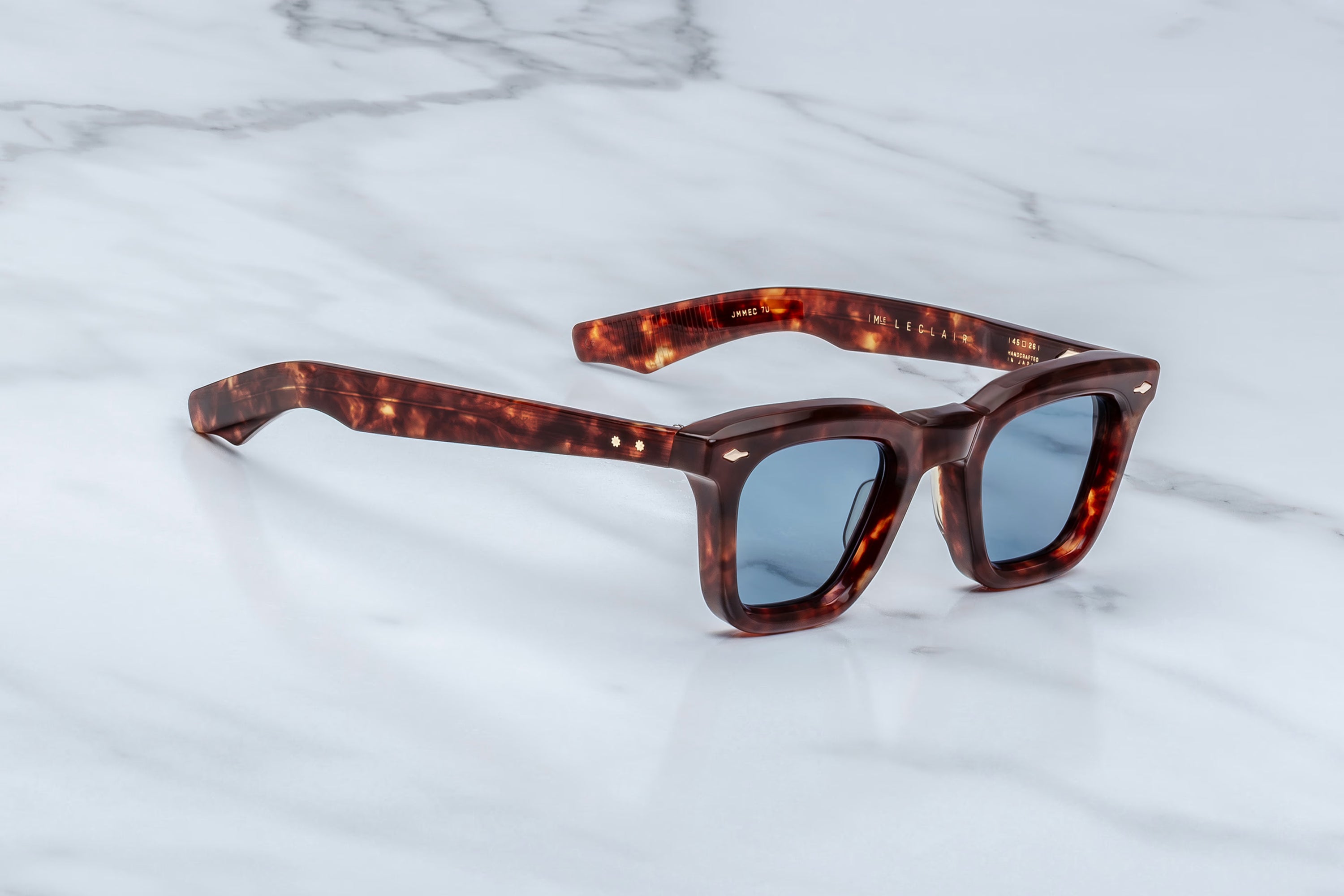 Tortoiseshell sunglasses on a marble surface
