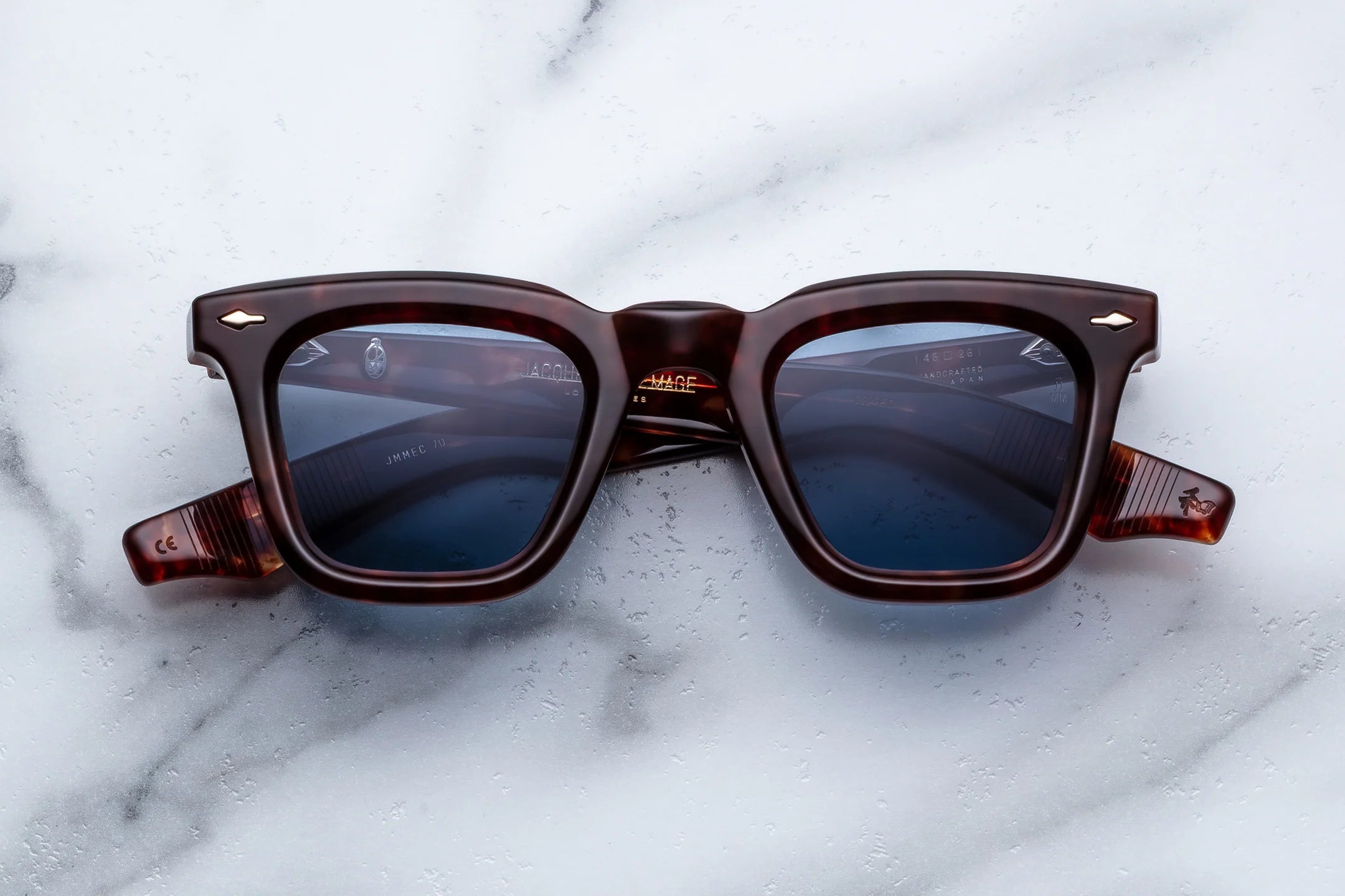 Brown sunglasses with a reflective surface on a marble background