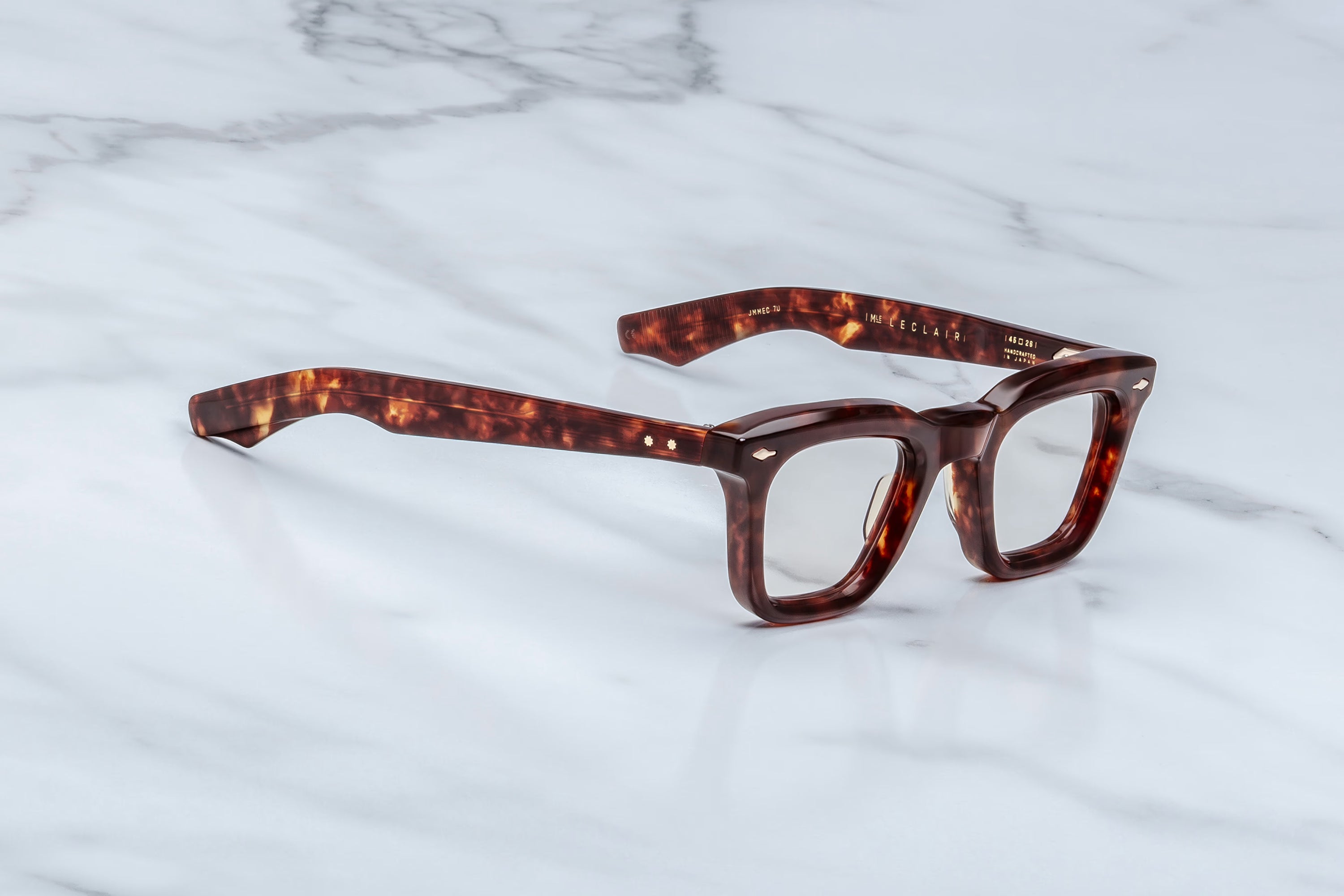 Tortoiseshell eyeglasses on a marble surface
