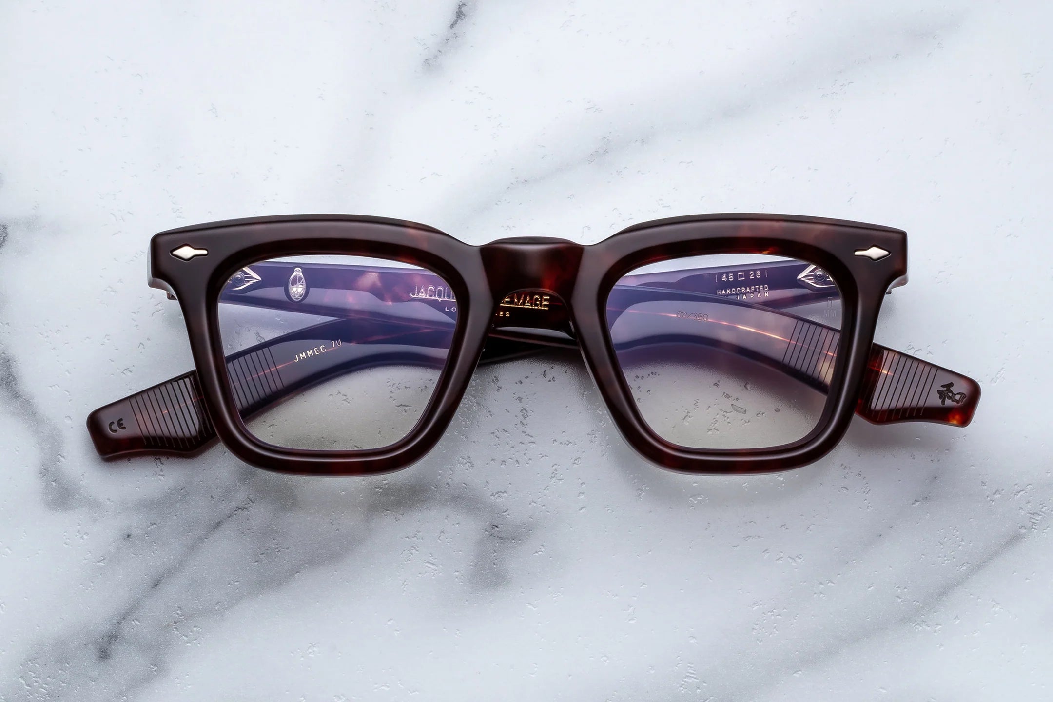 Brown eyeglasses on a marble surface