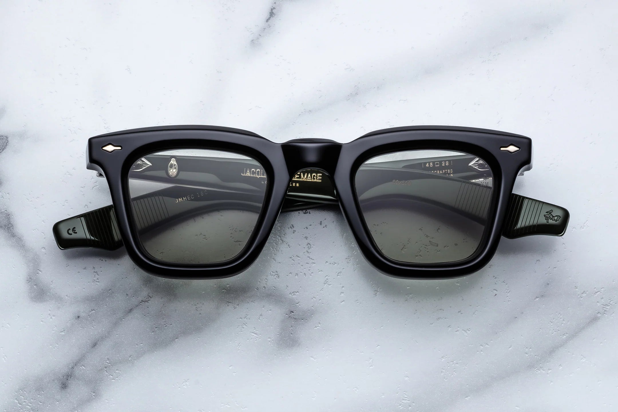 Black sunglasses on a marble surface