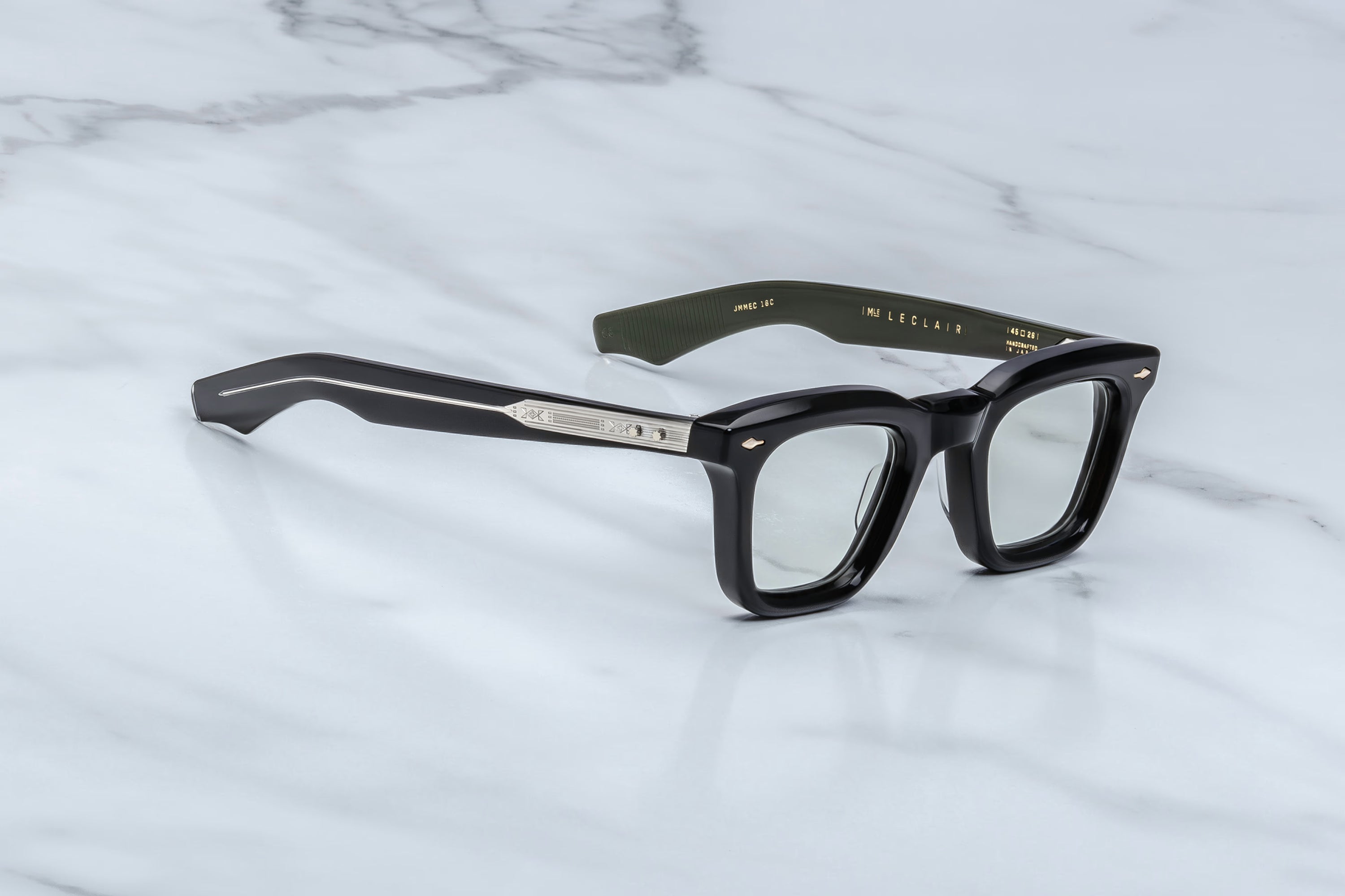 Black eyeglasses on a marble surface