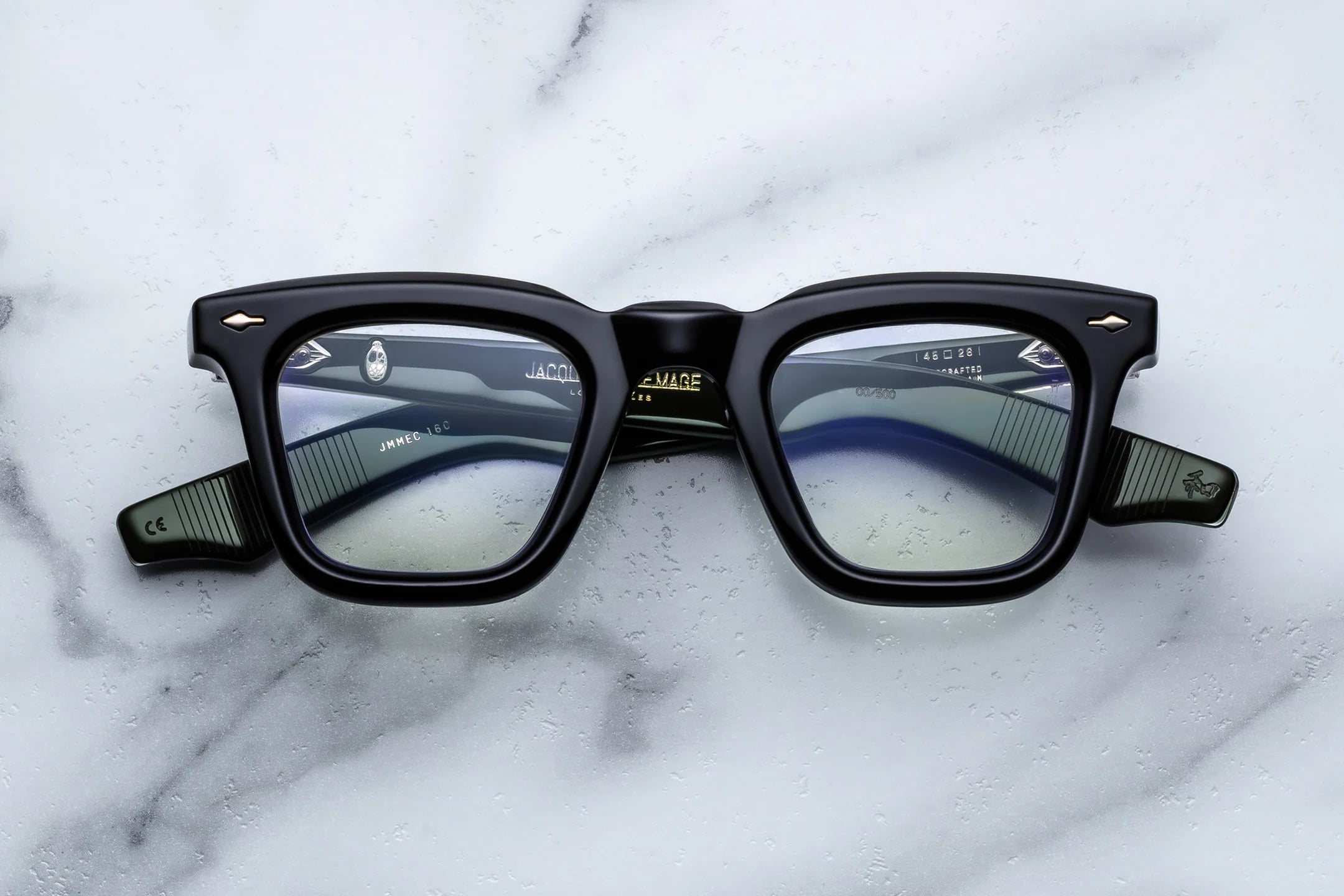 Black eyeglasses on a marble surface