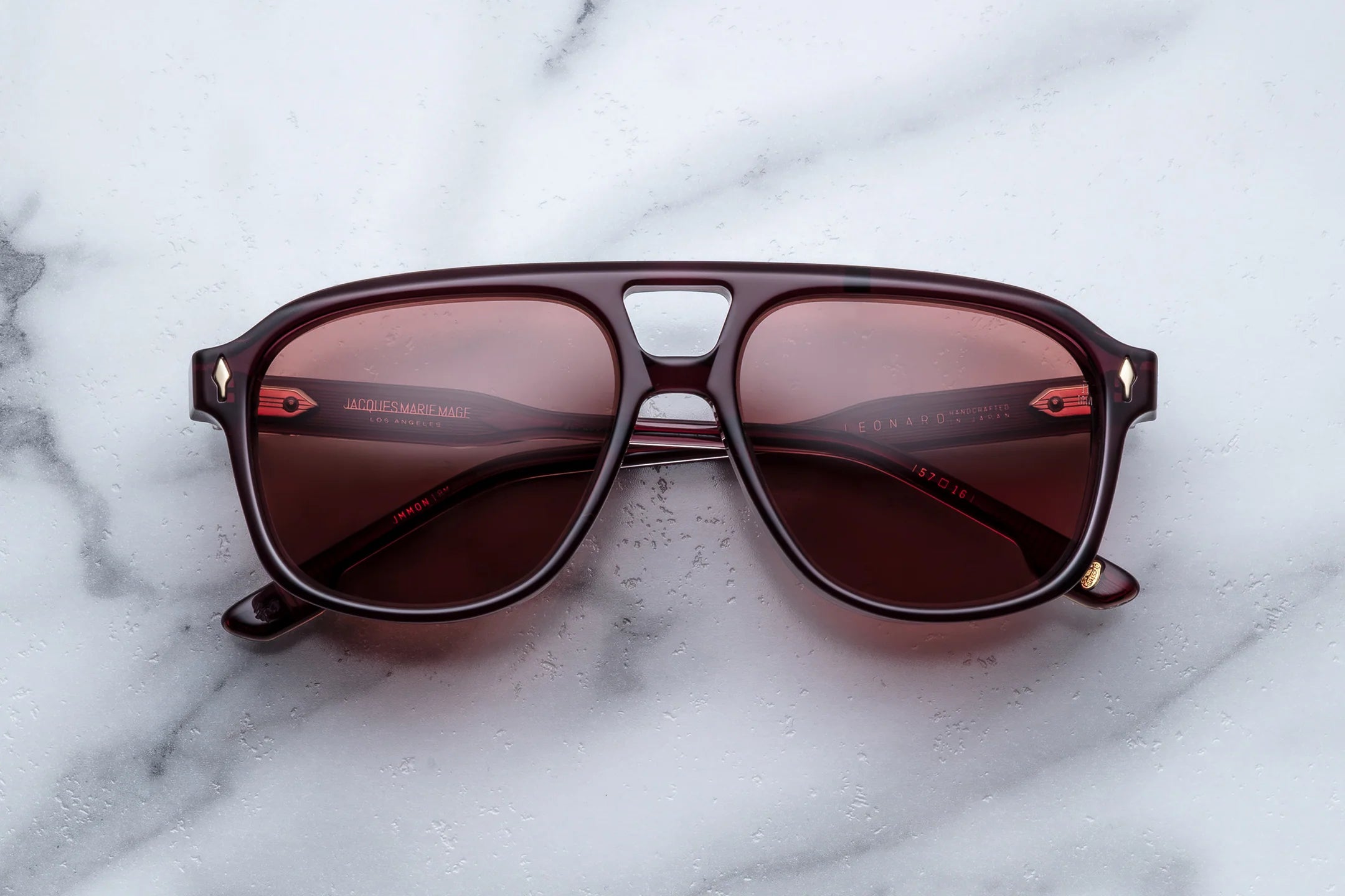 Sunglasses with brown lenses on a marble surface