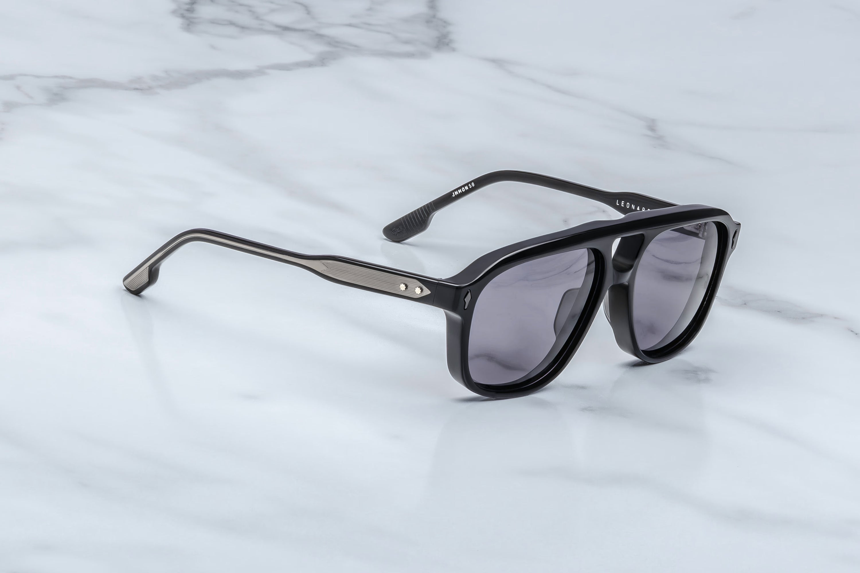 Black sunglasses on a marble surface