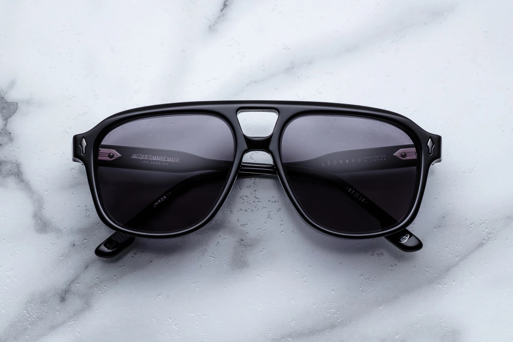 Black sunglasses on a marble surface