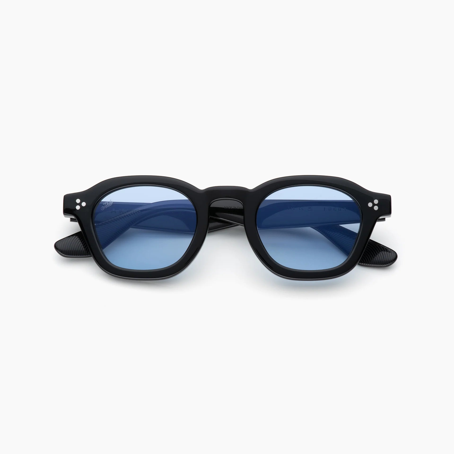 Black round acetate sunglasses with blue tinted lenses, silver rivet detailing, and black textured temples, shown from the front on a white background.