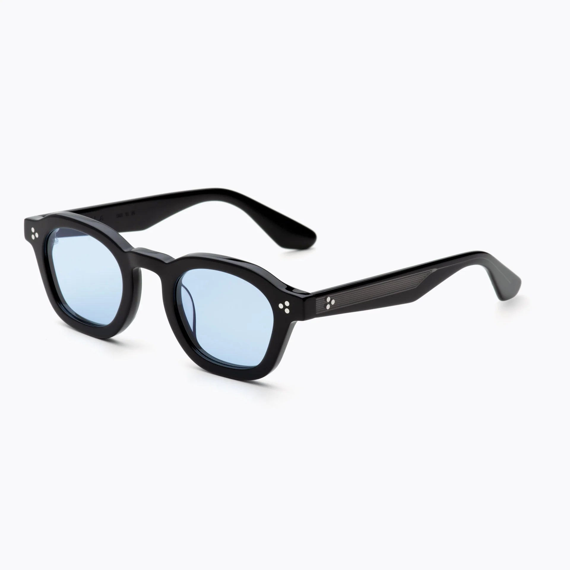 Black acetate sunglasses with light blue tinted lenses, silver rivet detailing, and textured temples, shown at an angled side view on a white background.
