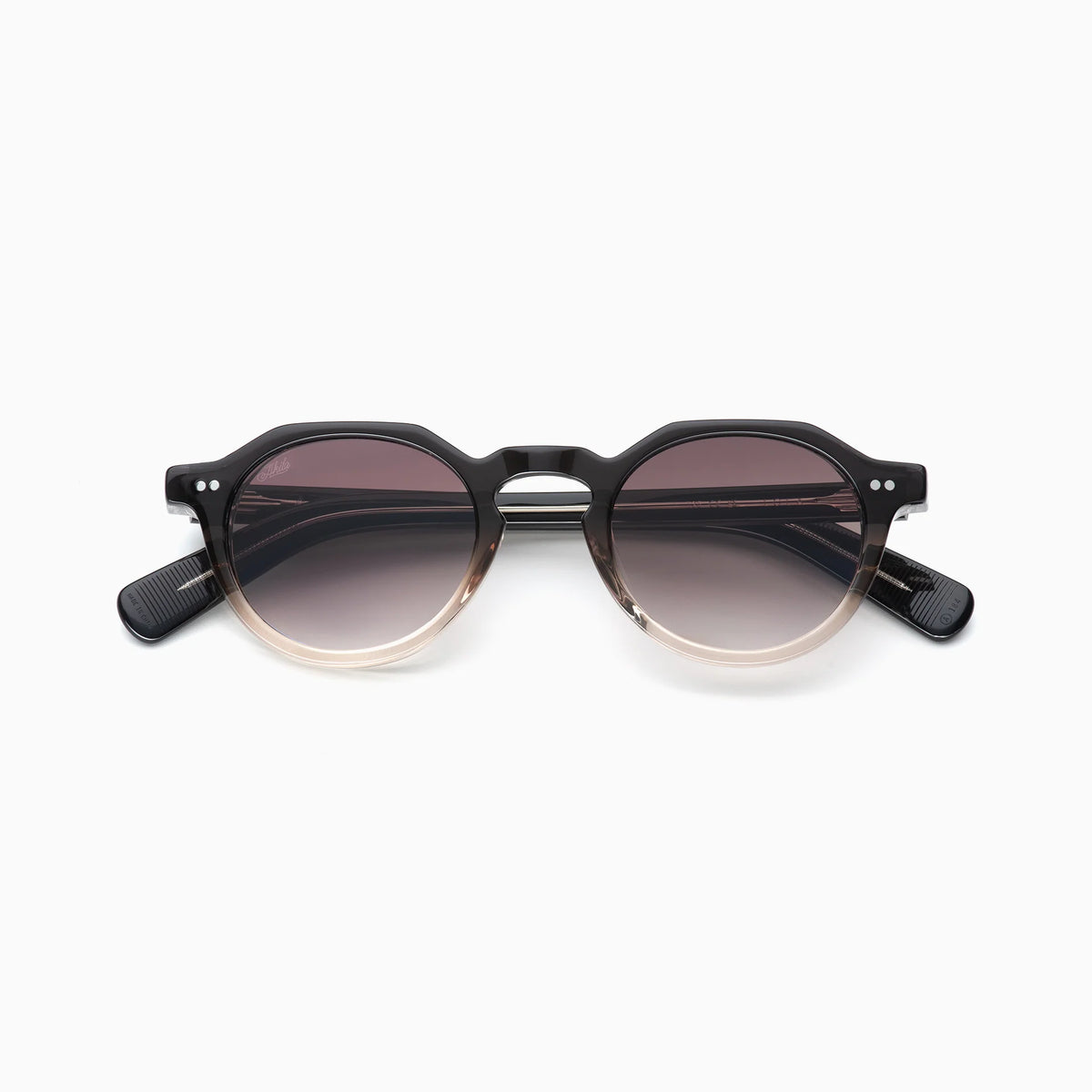 The Akila Lola round sunglasses by Akila feature gradient lenses that fade from dark at the top to light at the bottom, set in a contemporary black frame with subtle brown detailing along the bottom, and are displayed against a plain white background.