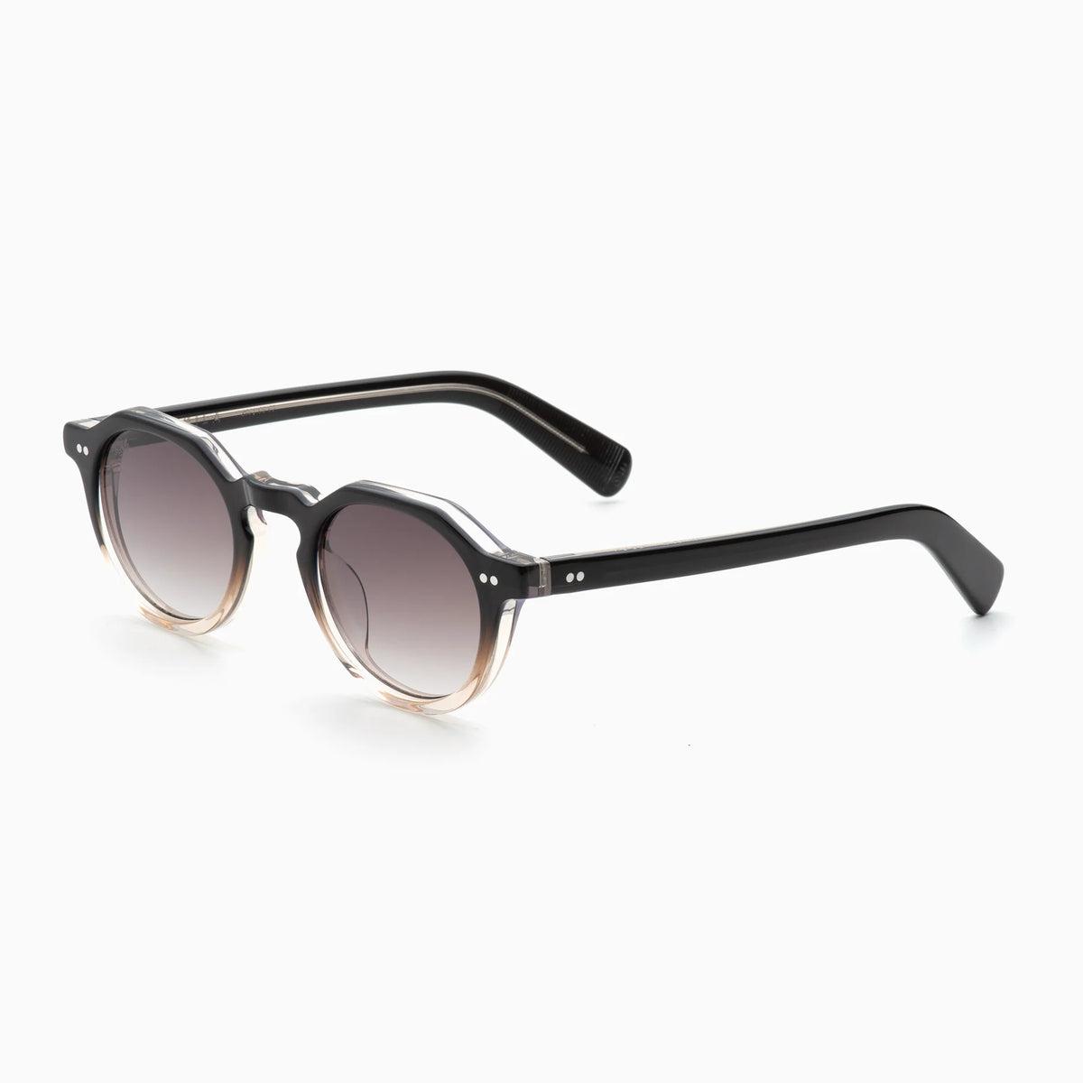 Akila Lola sunglasses by Akila feature a contemporary round eyeglass frame with a black-to-clear gradient finish and dark lenses, shown angled on a white background. The design is completed with paddle-shaped temples for added style and comfort.
