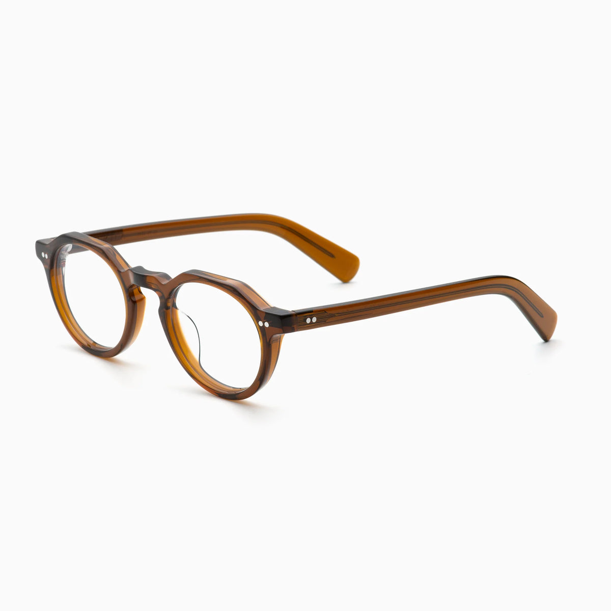 The Akila Lola by Akila is a pair of brown, round optical frames with thick rims and arms, displayed at an angle on a white background. This contemporary design is accented with two small metallic dots near each hinge.