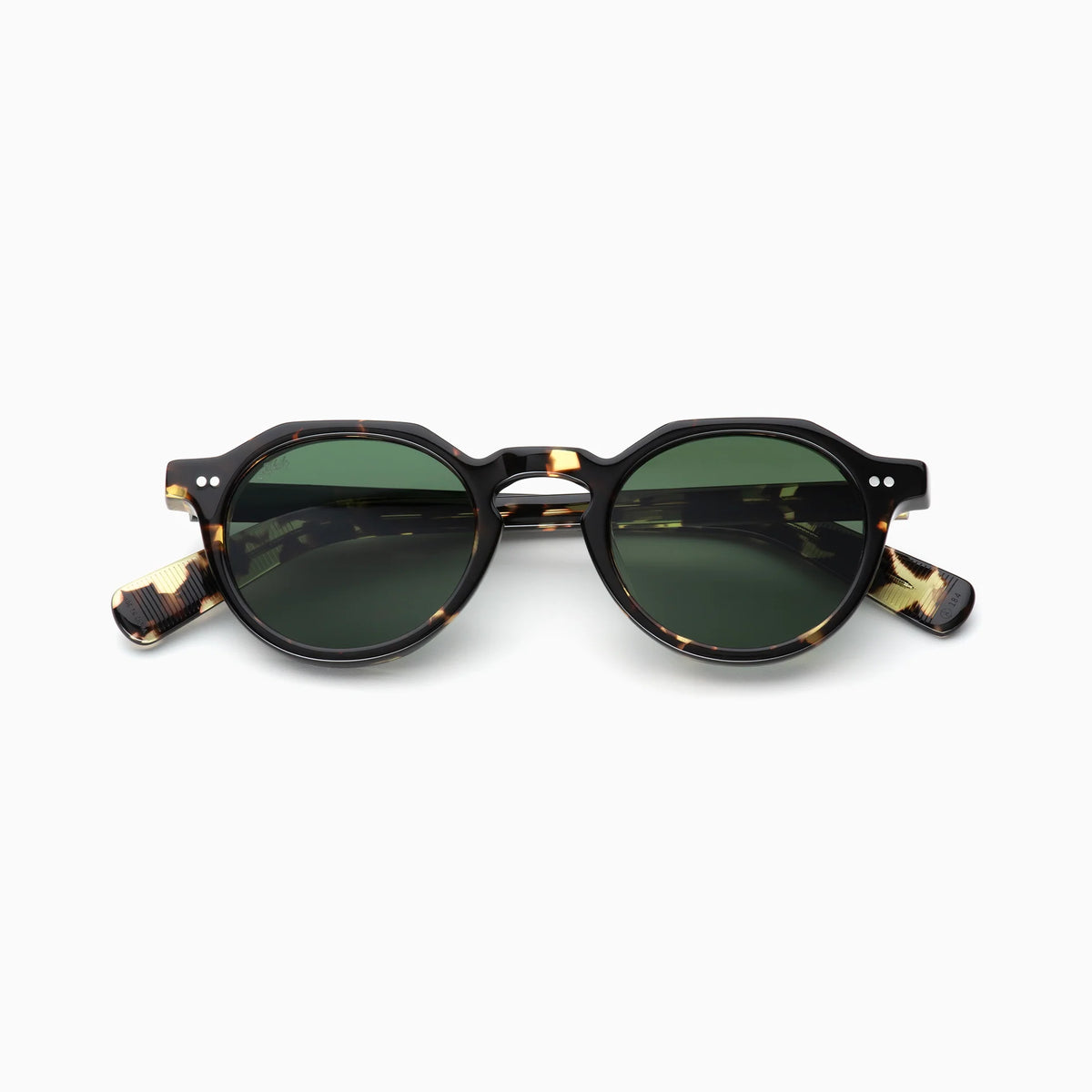 The Akila Lola by Akila is a pair of round tortoiseshell sunglasses with green-tinted lenses, showcased on a white background. This contemporary frame features a keyhole bridge, paddle-shaped temples, and two small silver dots on each front corner.