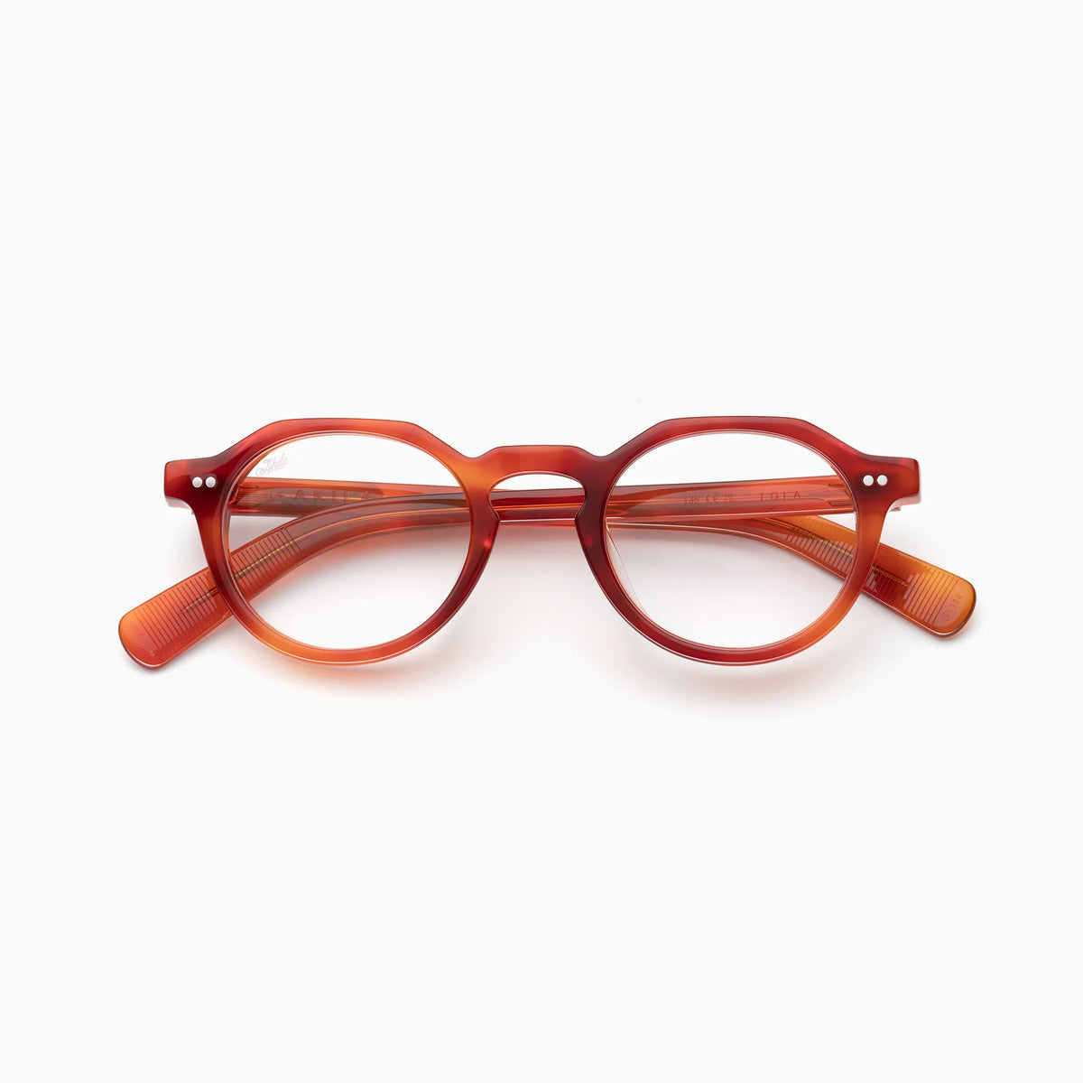 The Akila Lola by Akila are round, reddish-orange optical frames crafted from transparent material with distinct rims, showcased against a white background.