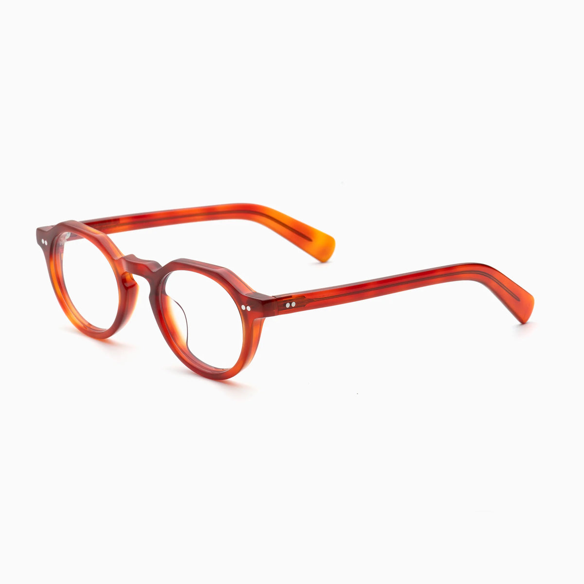 The Akila Lola by Akila showcases round, translucent orange optical frames with thick temples, seen from a slight angle against a white background. These contemporary eyeglasses are accented by two small metal rivets on each side of the front frame.