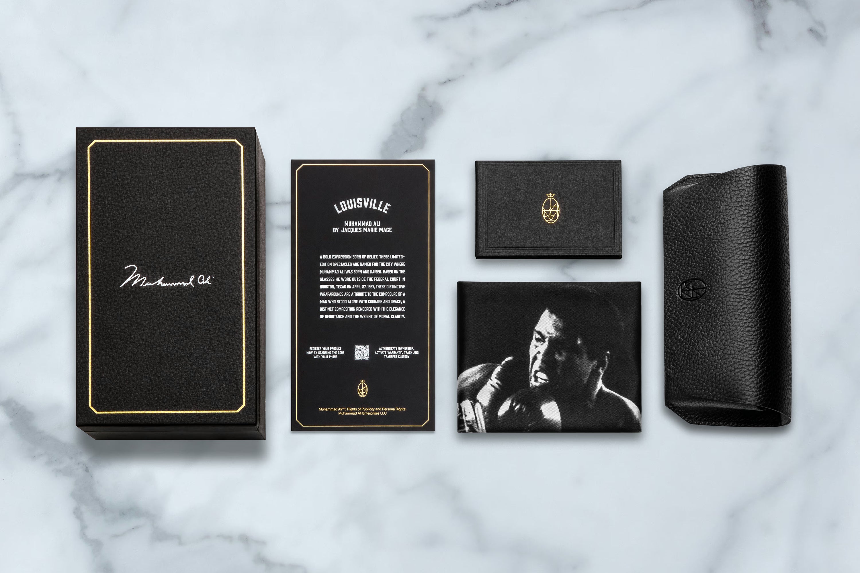 Collection of black and gold product packaging on a marble surface