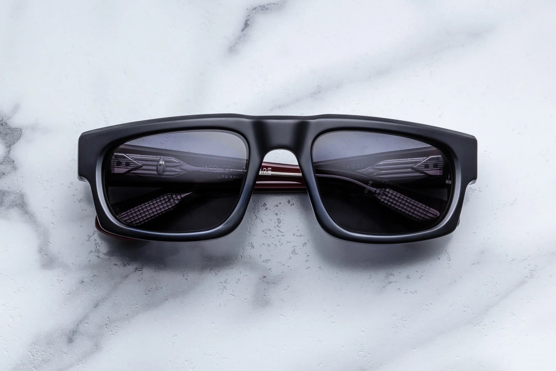 Black sunglasses on a marble surface