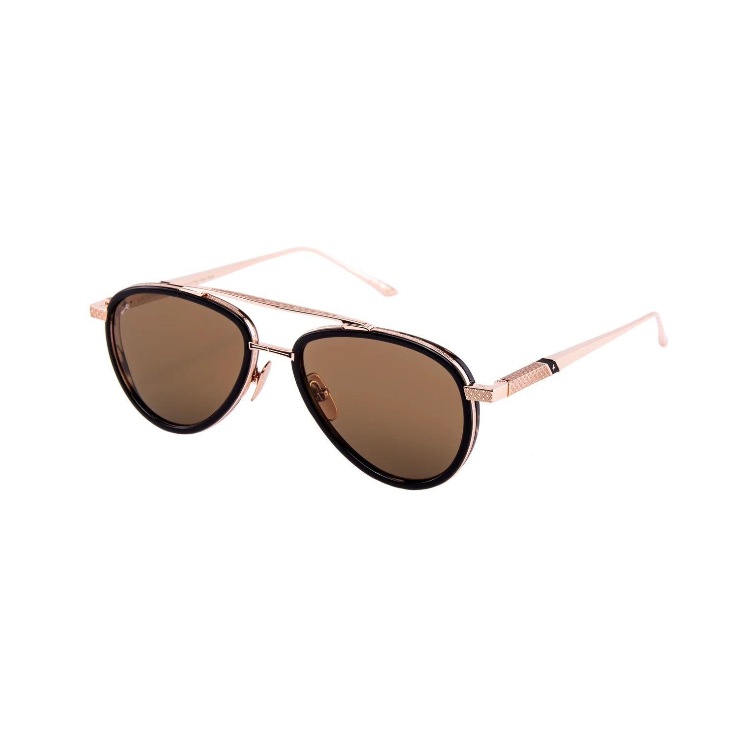 The Leisure Society Lucienne sunglasses by Leisure Society are brown-tinted luxury eyewear crafted from titanium in a classic aviator shape, featuring a sleek gold metal frame with black rim accents and shown against a white background.