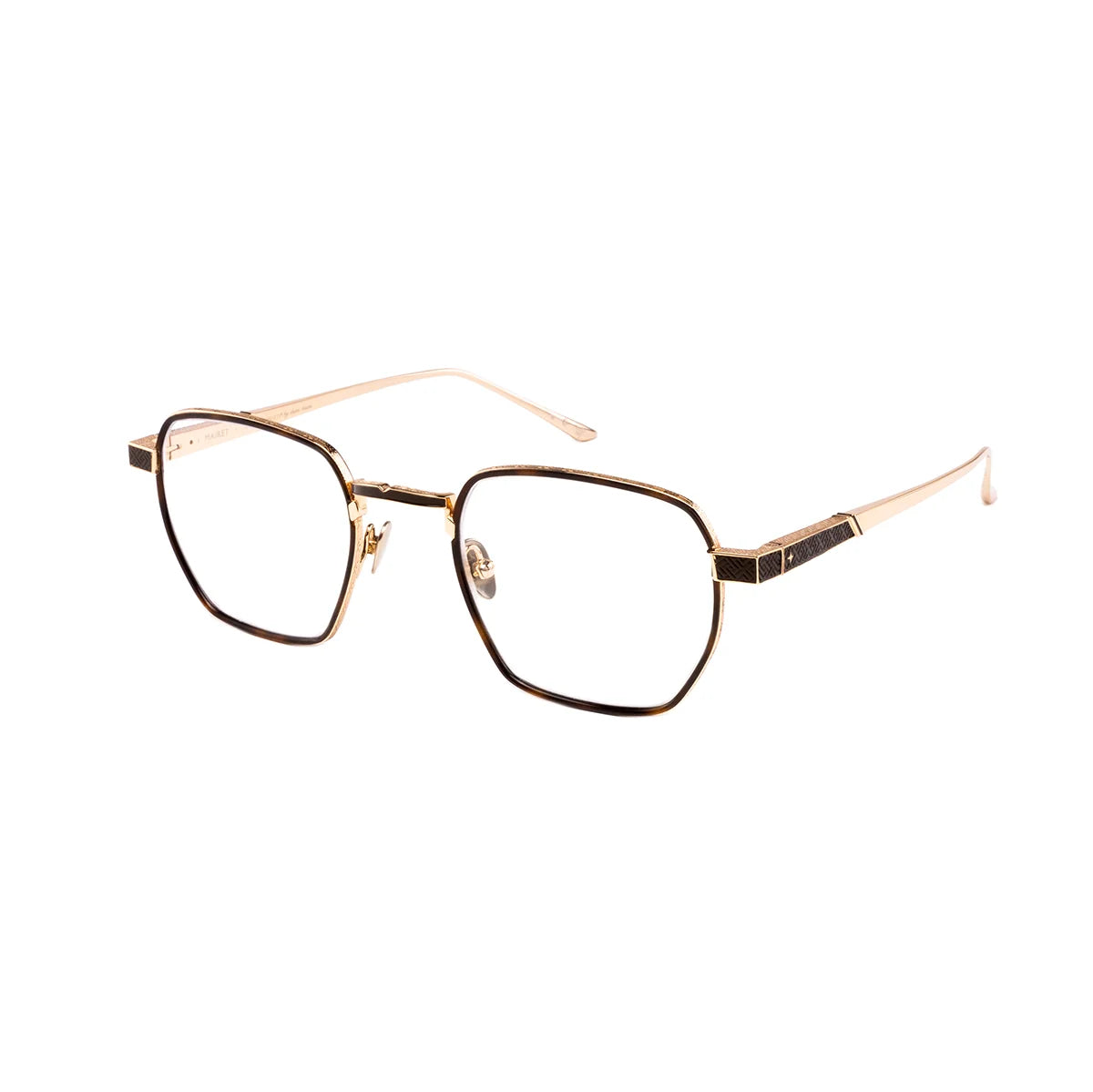 The Leisure Society Mairet glasses by Leisure Society feature geometric, hexagonal gold-rim frames made from lightweight titanium and clear lenses, showcased against a plain white background.