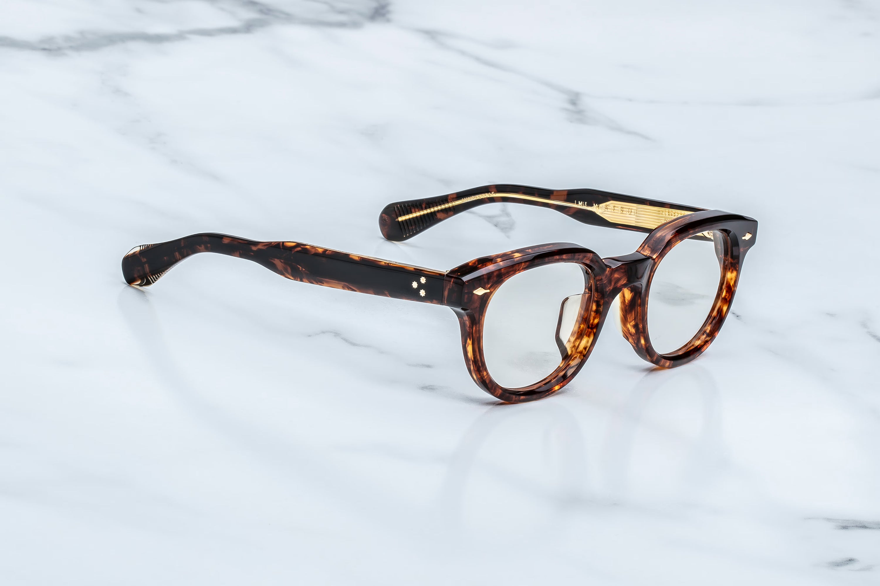 Tortoiseshell eyeglasses on a marble surface