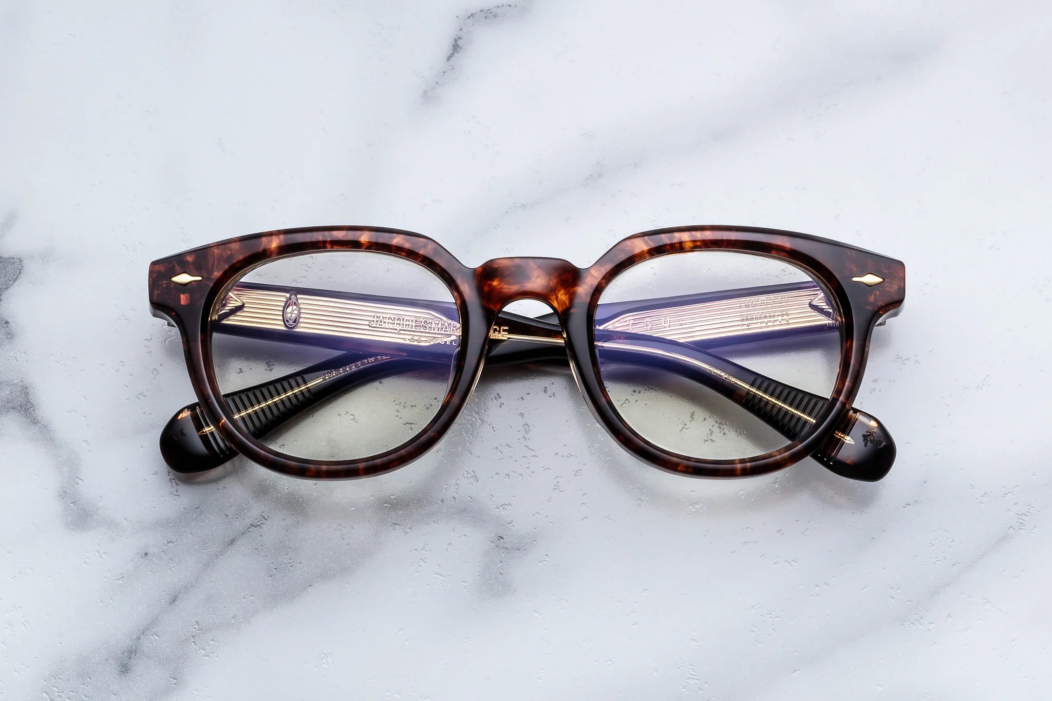 Tortoiseshell eyeglasses on a marble surface