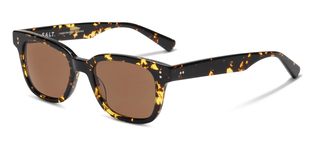 The SALT. Max sunglasses by SALT. feature a classic tortoiseshell design with rectangular brown lenses, thick acetate frames, and two small silver dots on each temple. Handcrafted in Japan from premium Japanese acetate, these vintage unisex sunglasses offer exceptional quality and timeless style.