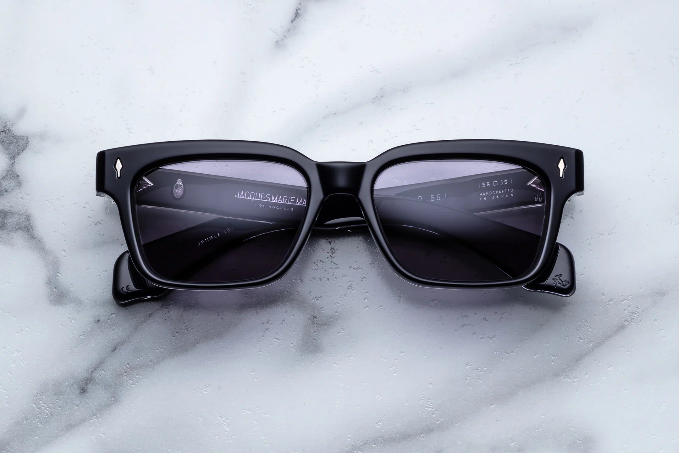 Black sunglasses on a marble surface