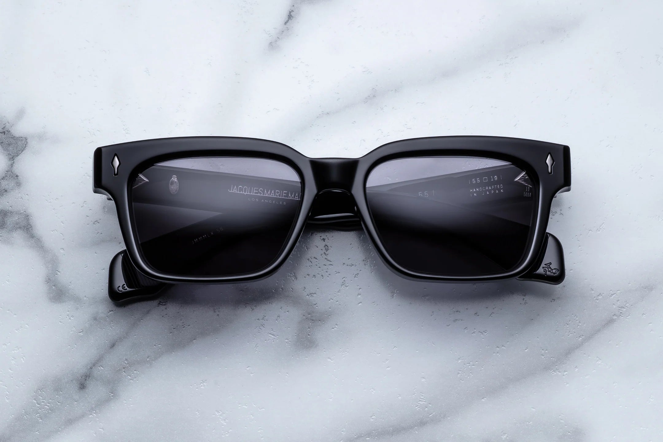 Black sunglasses on a marble surface