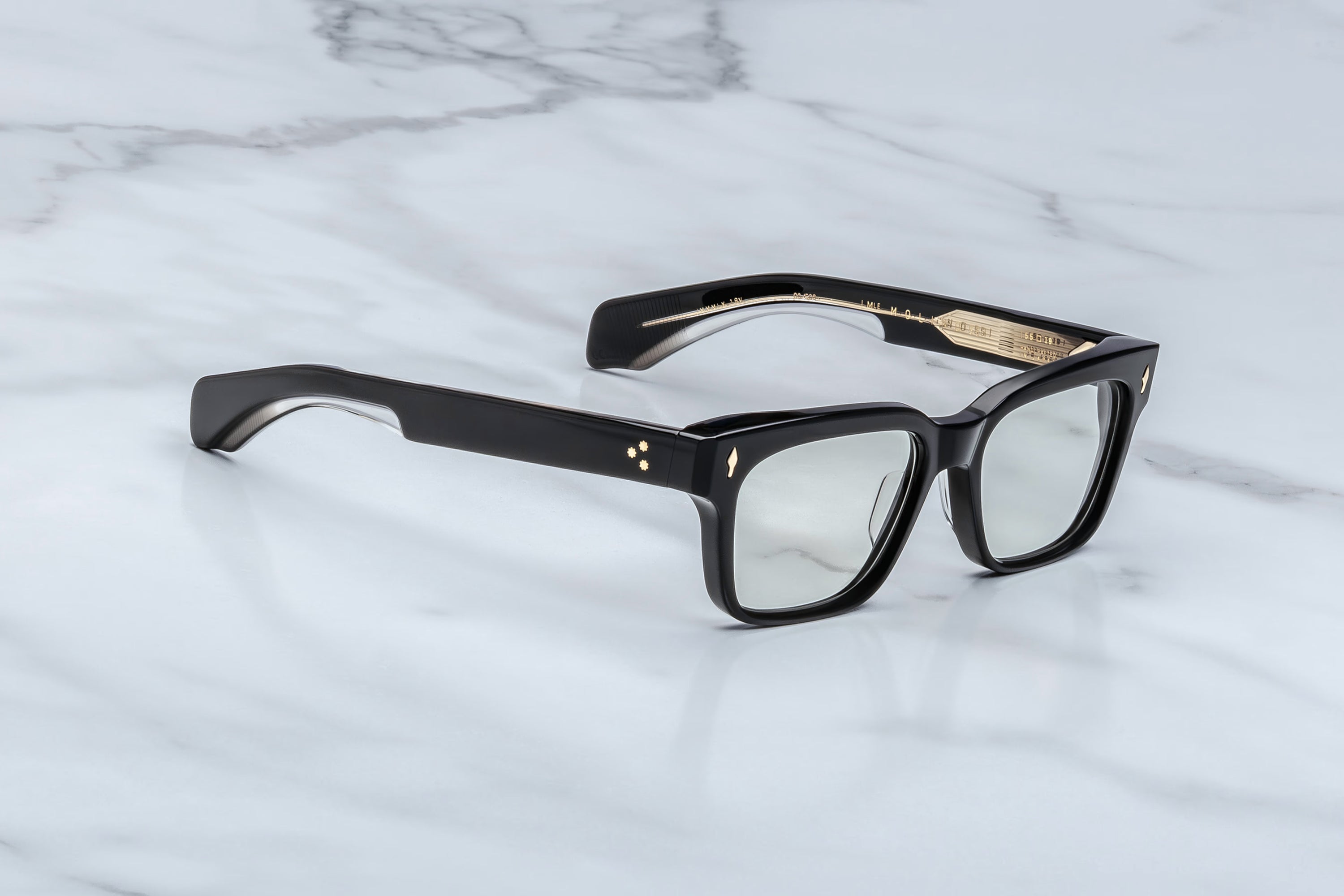 Black eyeglasses on a marble surface