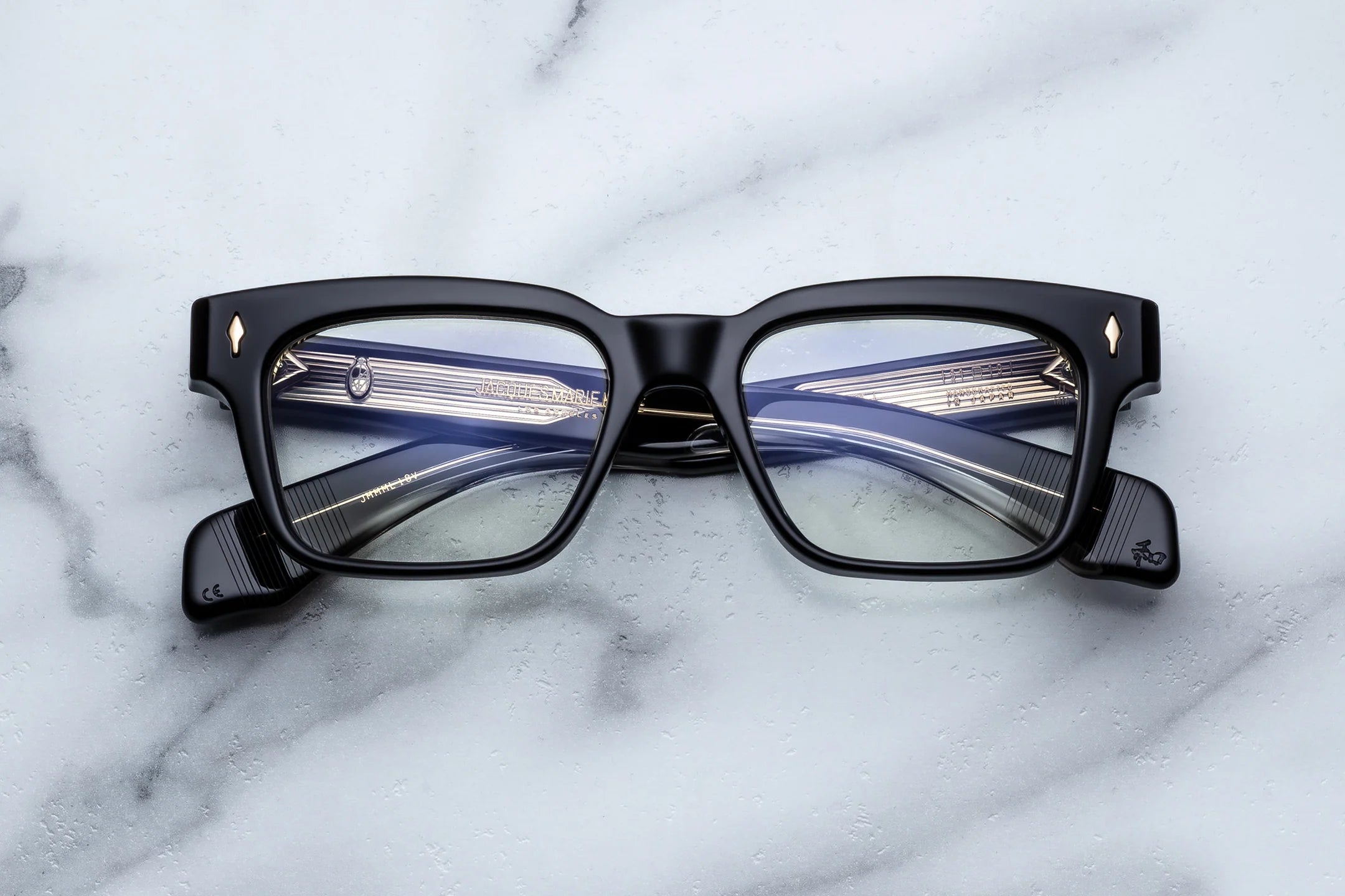 Black eyeglasses on a marble surface