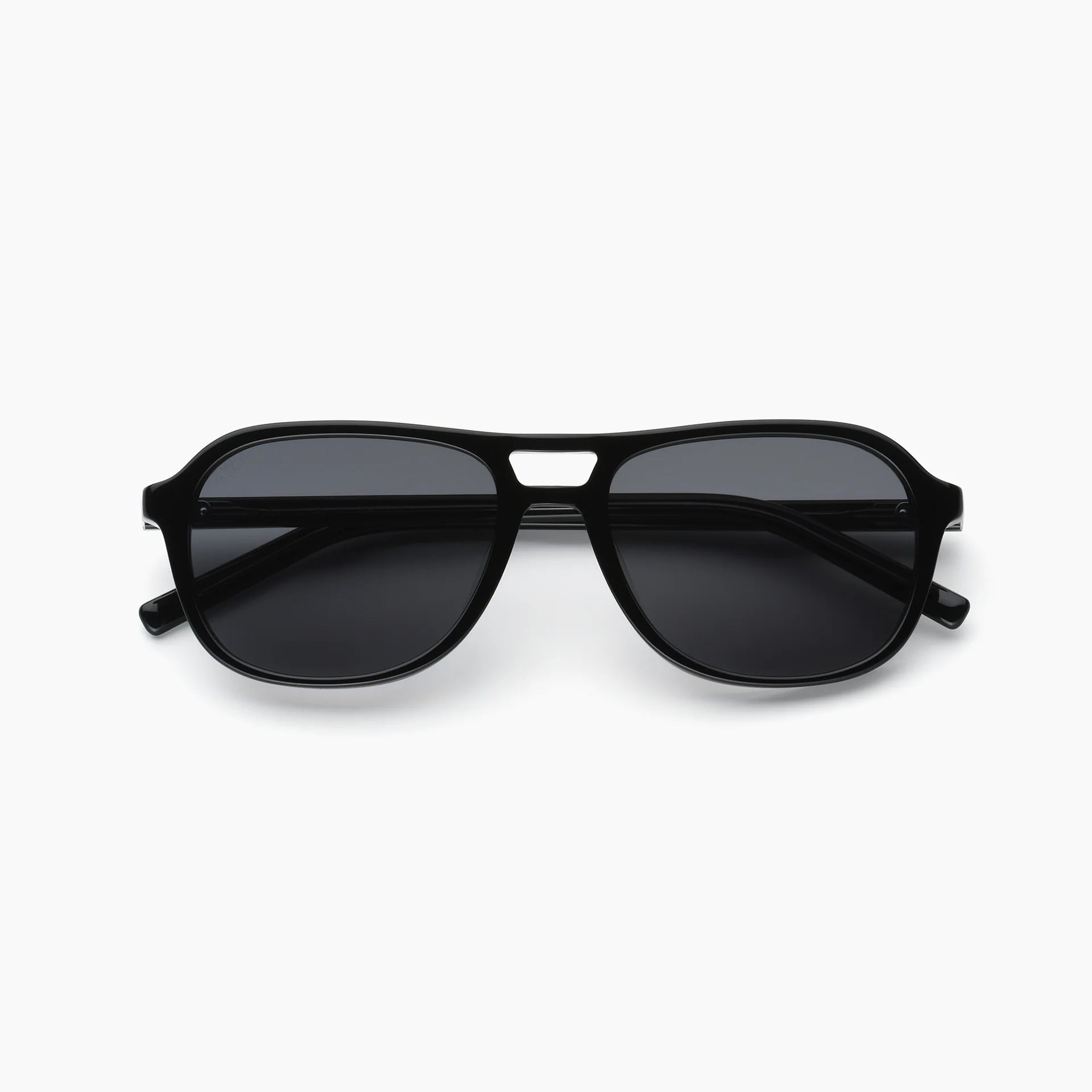 Black sunglasses with gold accents on a white background